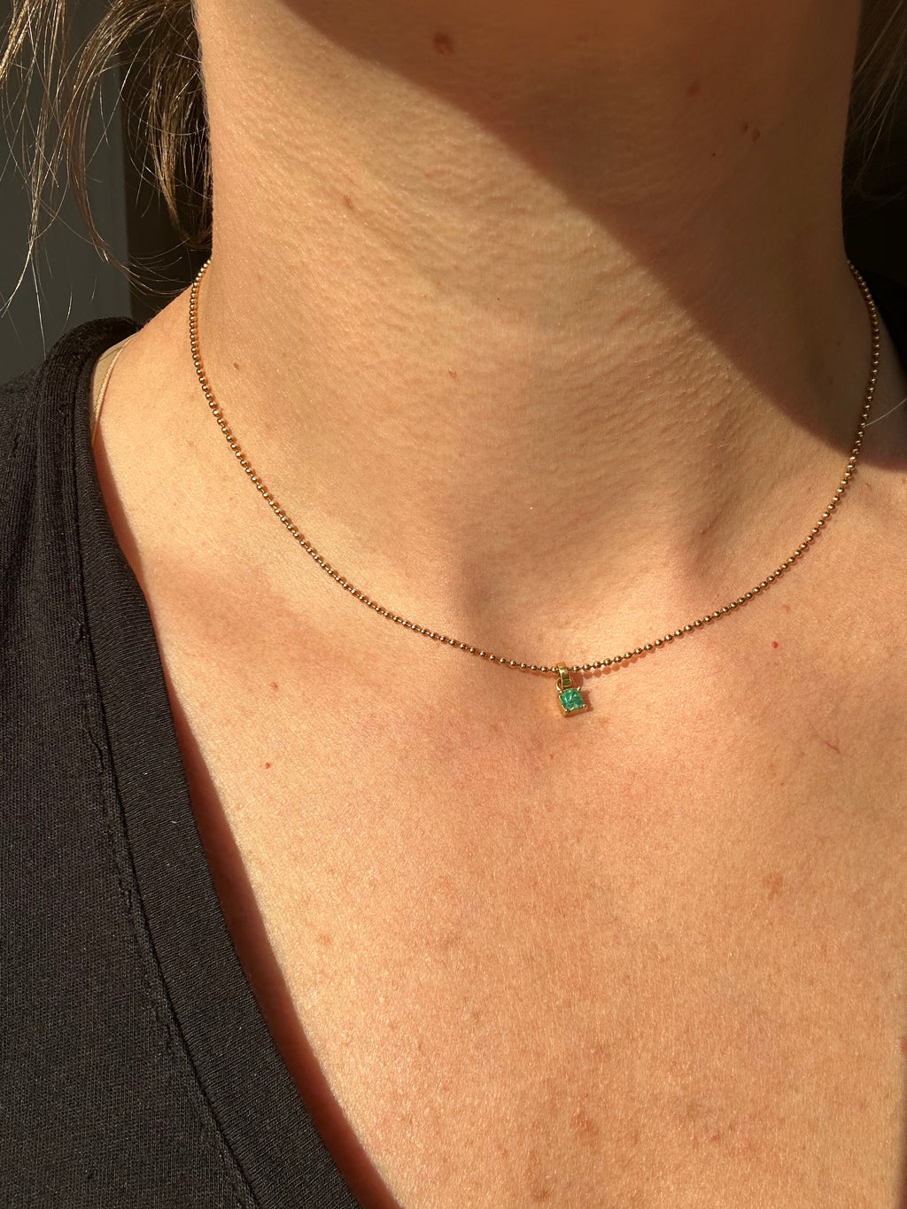 step cut square emerald and 18k gold charm