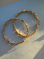 2" solid gold hoops with ribbon design