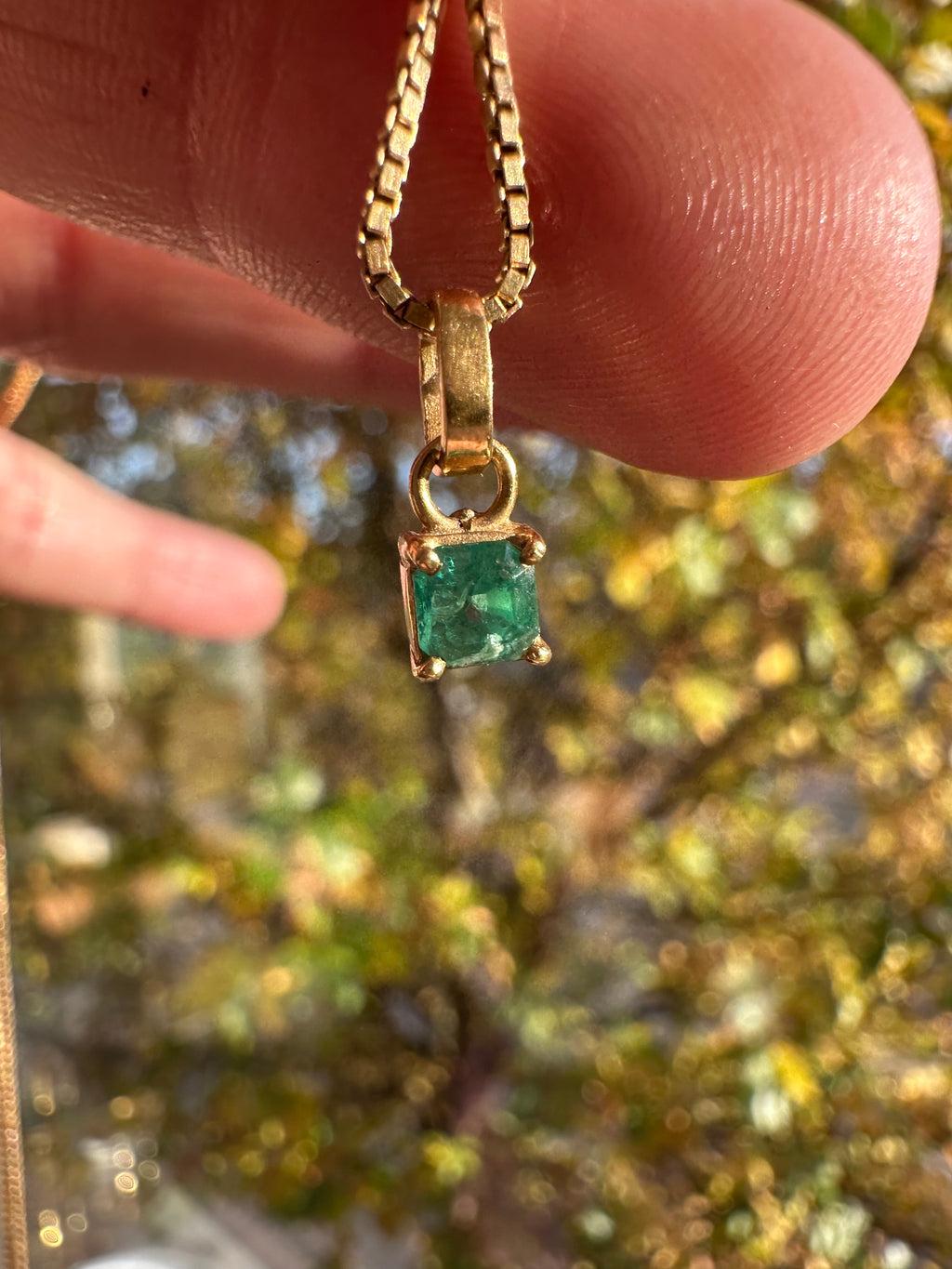 step cut square emerald and 18k gold charm