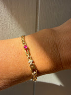 18k gold open bar link bracelet with ruby cabochon