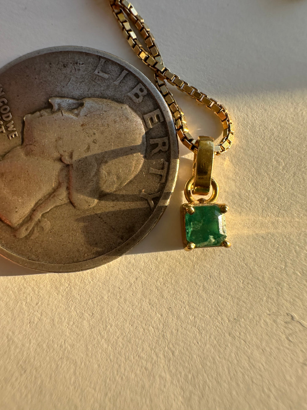 step cut square emerald and 18k gold charm