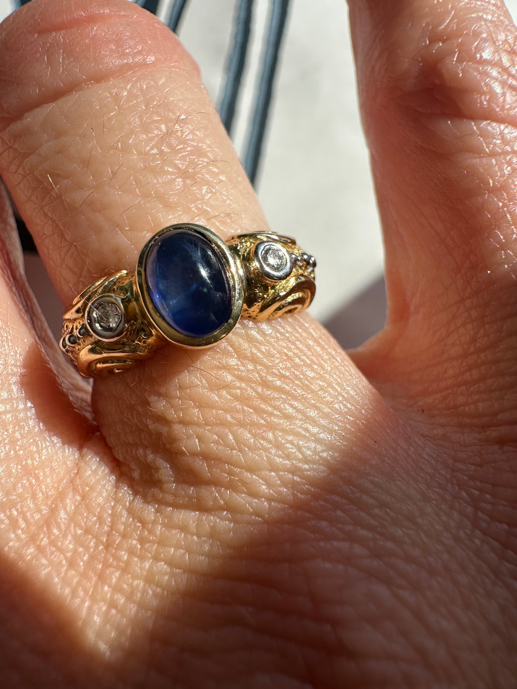 sapphire cabochon and bezel set diamonds