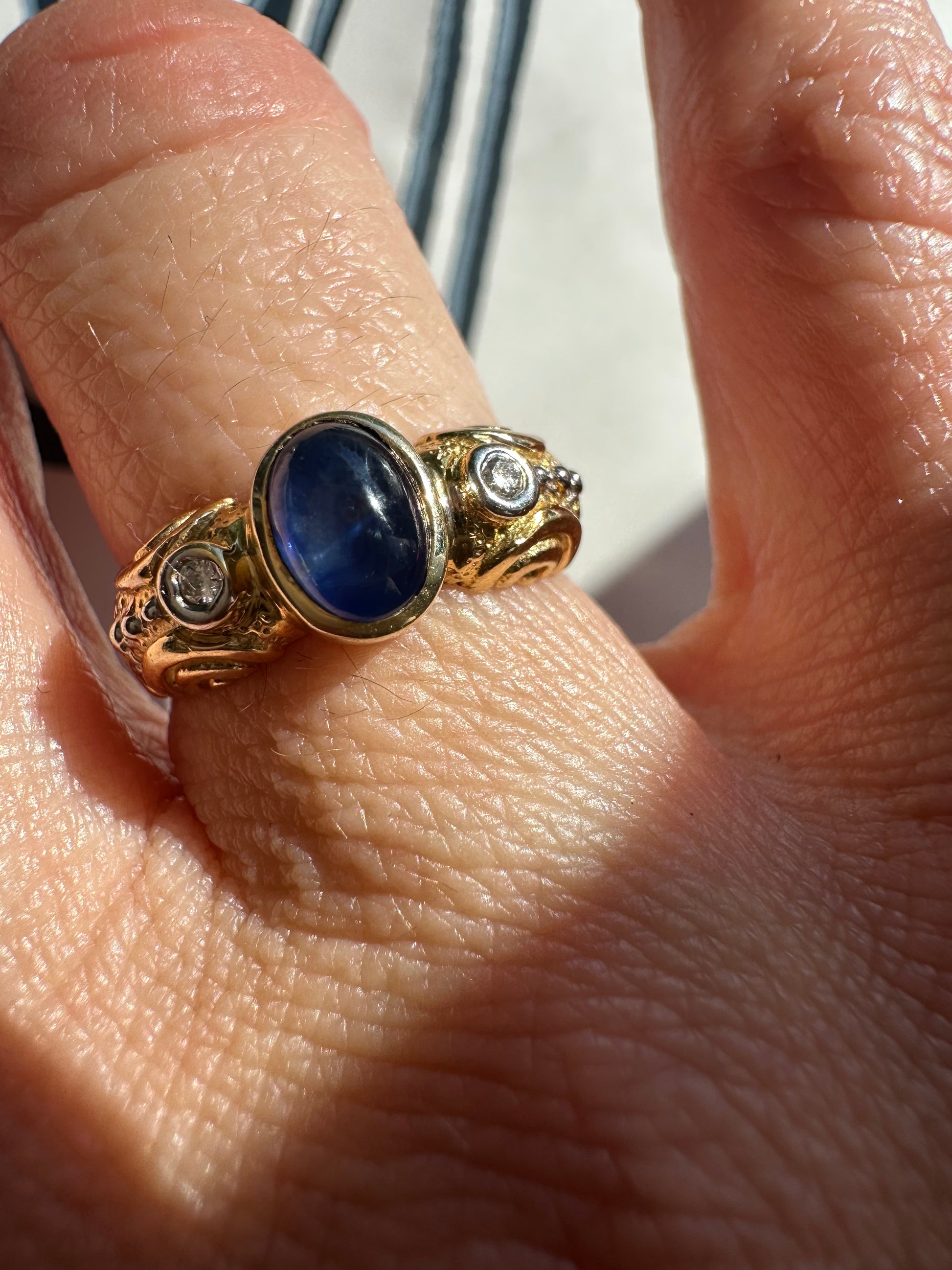 sapphire cabochon and bezel set diamonds