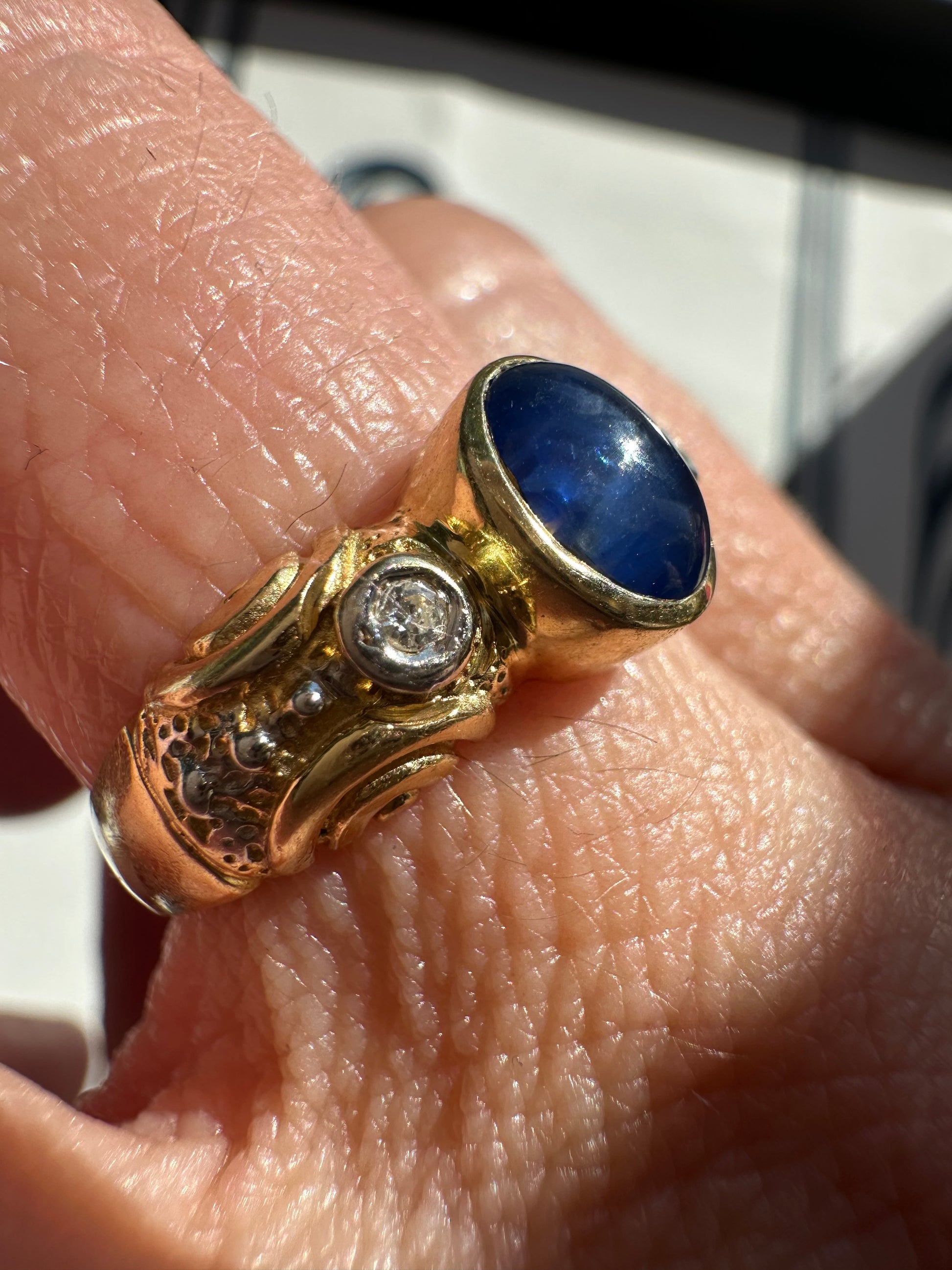 sapphire cabochon and bezel set diamonds