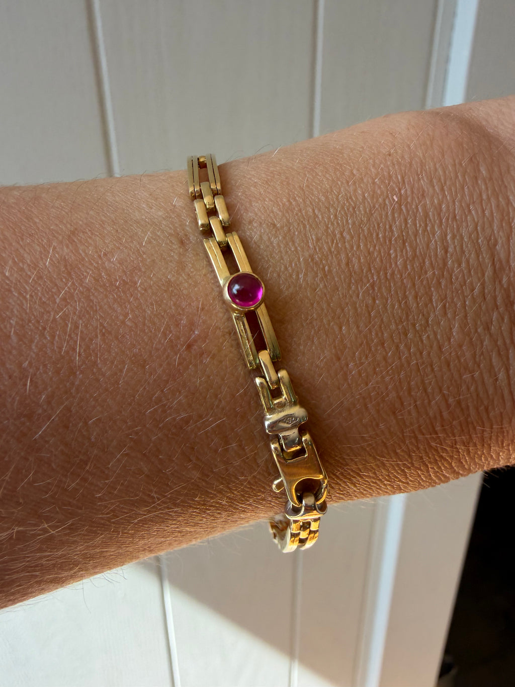 18k gold open bar link bracelet with ruby cabochon