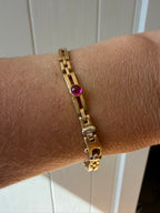 18k gold open bar link bracelet with ruby cabochon