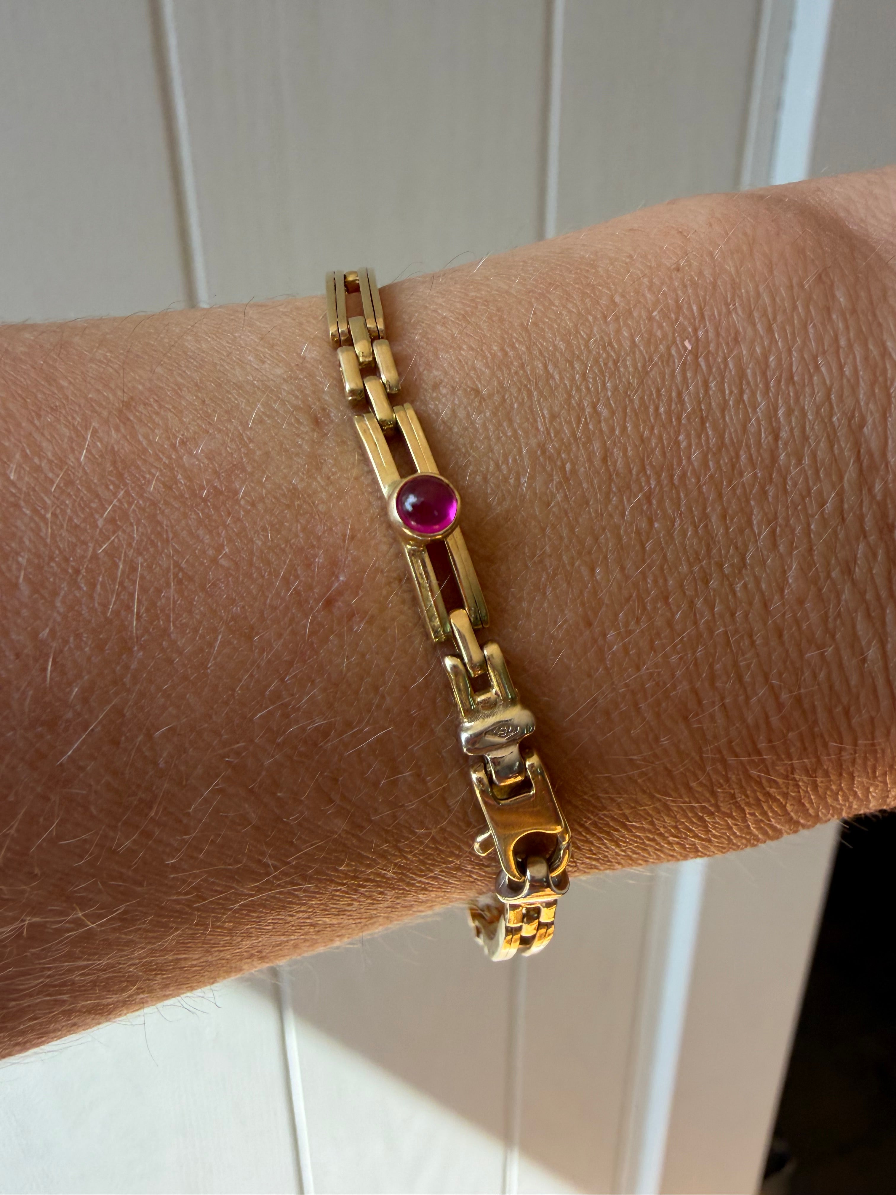 18k gold open bar link bracelet with ruby cabochon