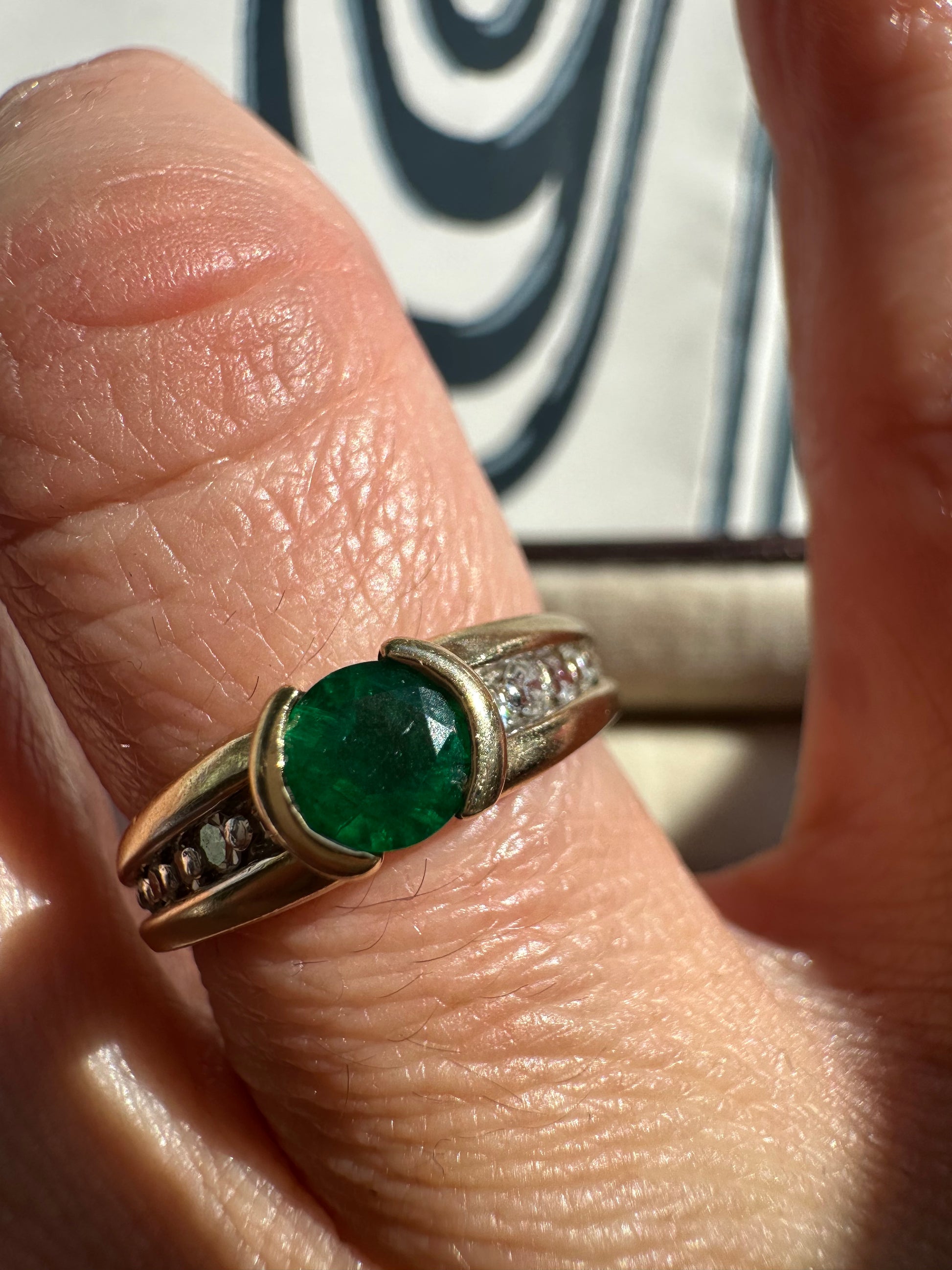round emerald and two tone diamond band