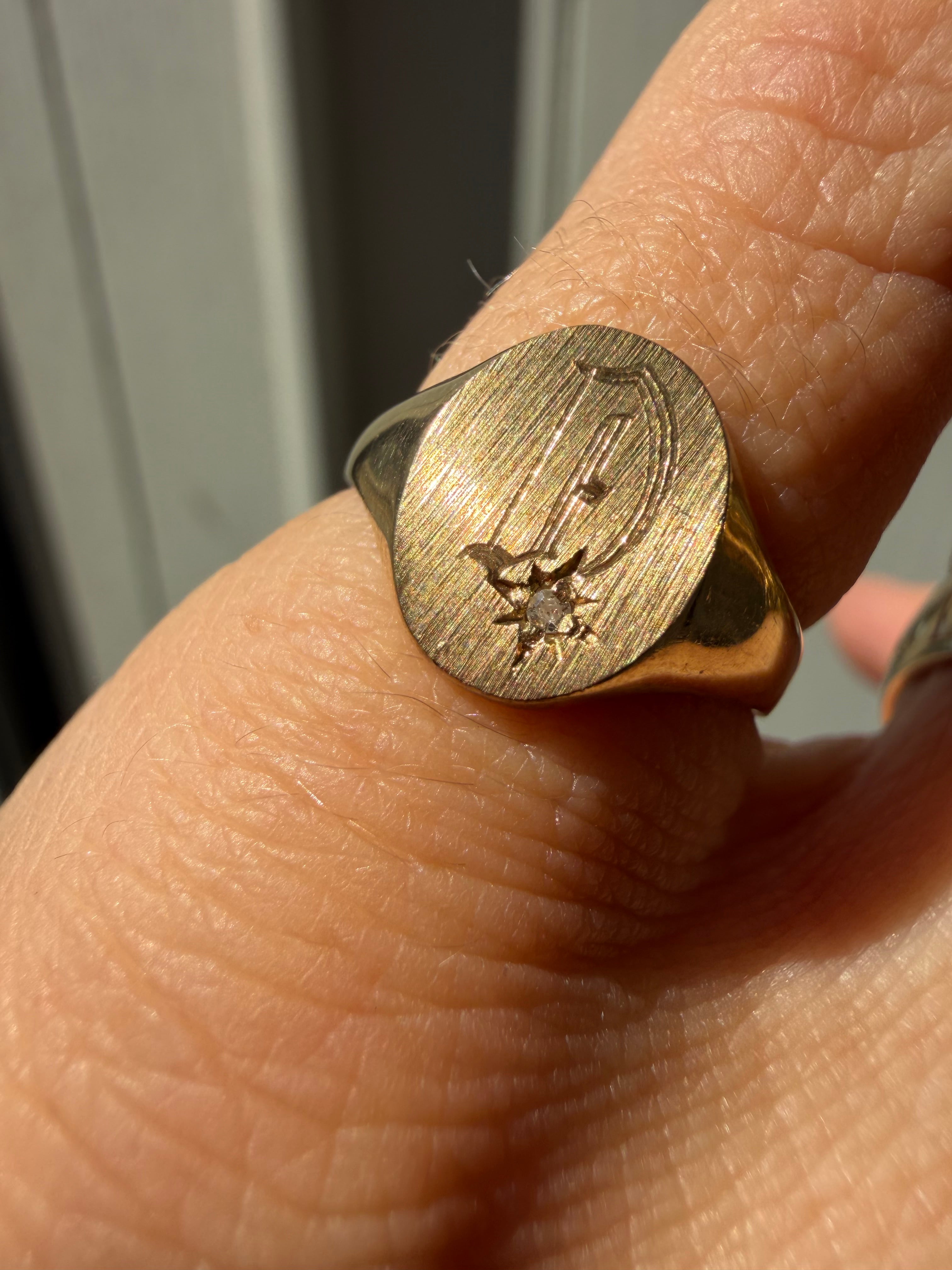 10k gold signet with faint D and burst diamond