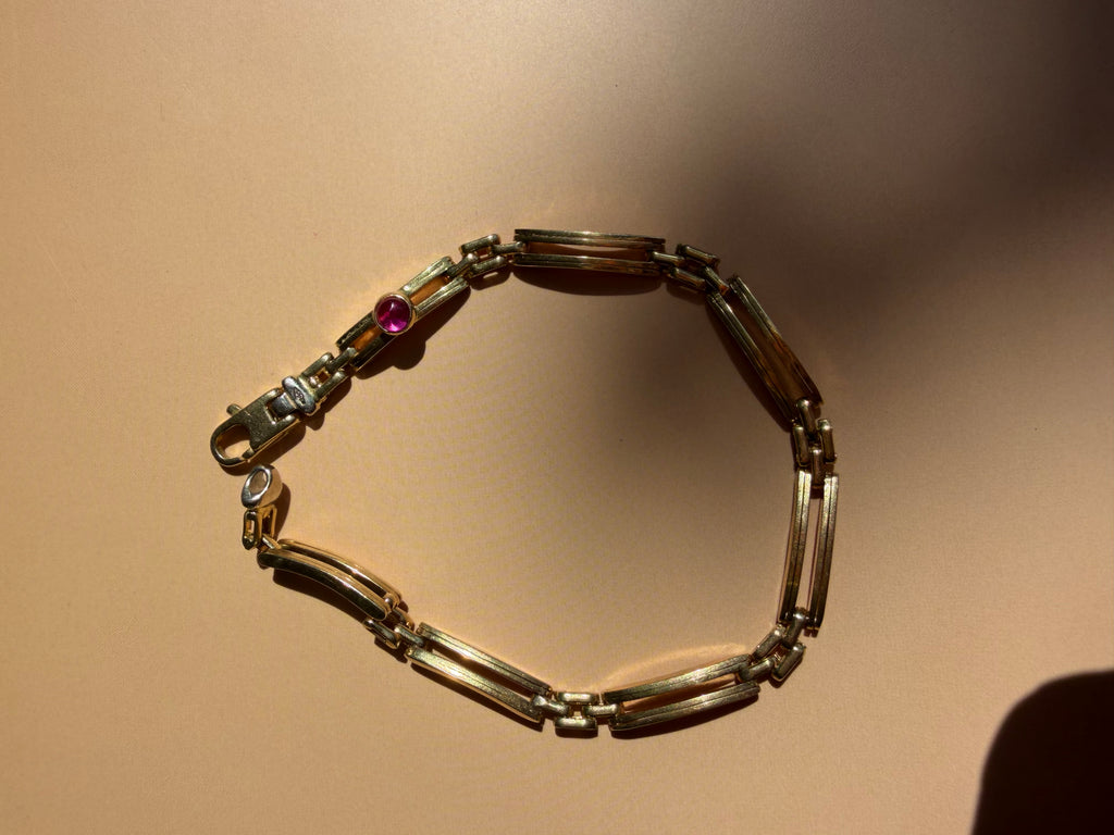 18k gold open bar link bracelet with ruby cabochon