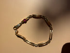 18k gold open bar link bracelet with ruby cabochon