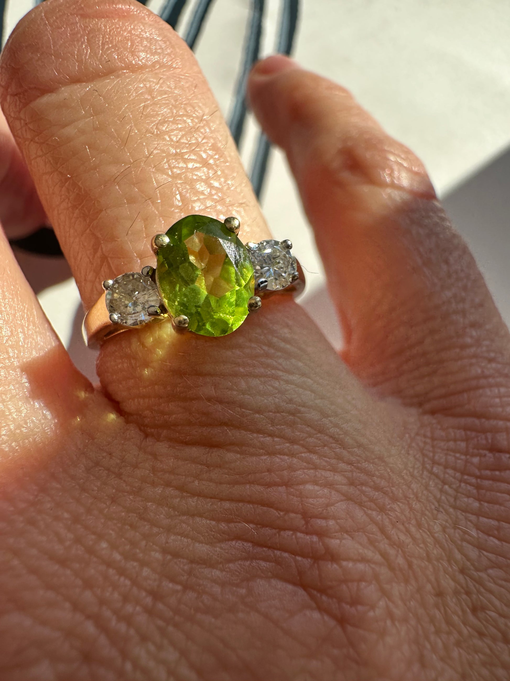 oval peridot and round cut diamond ring