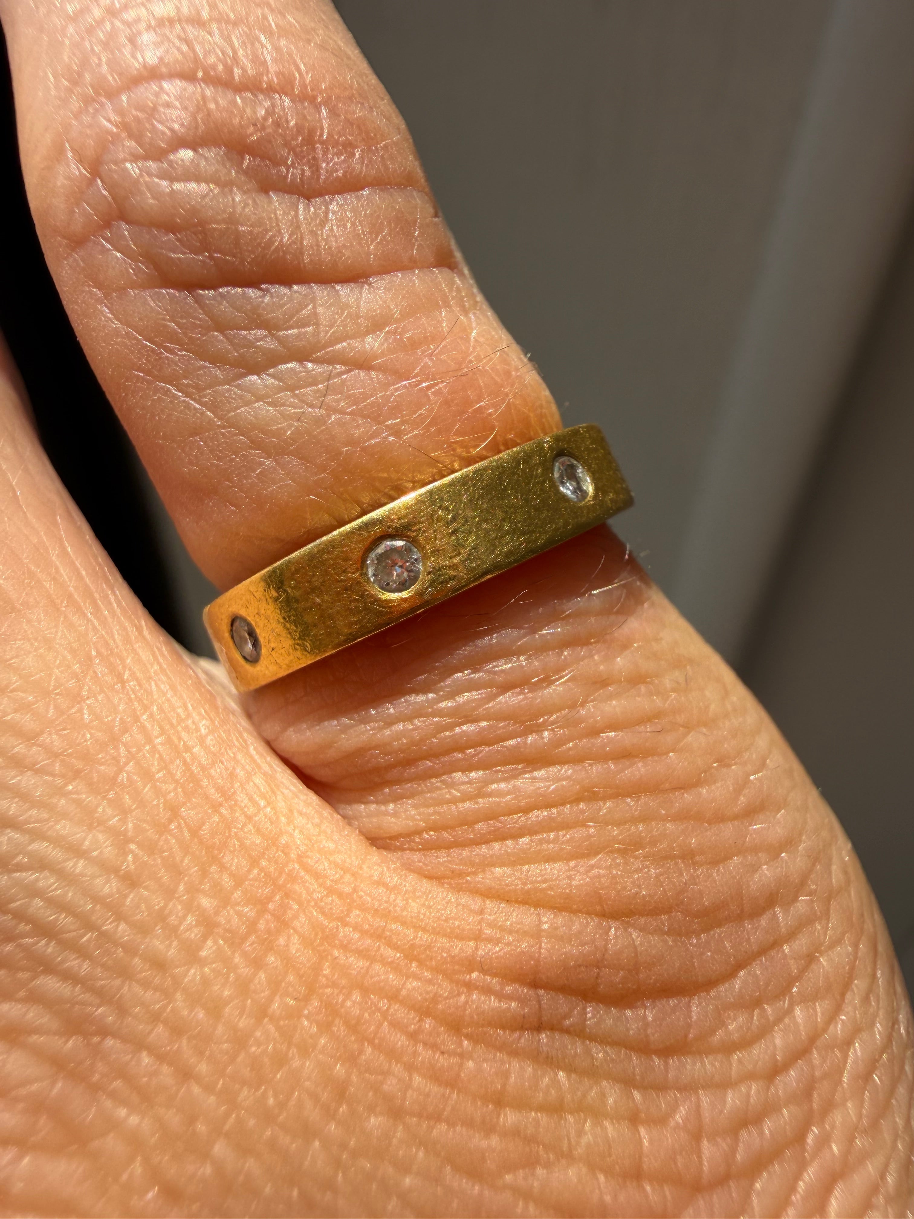 pipecut 18k gold eternity band with spaced diamonds