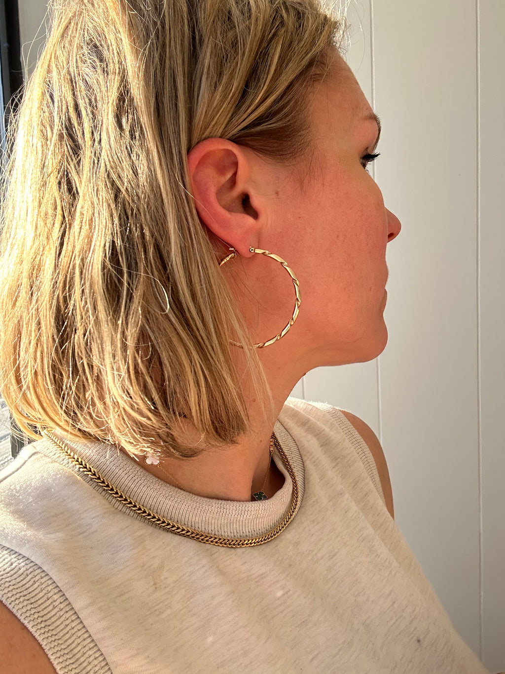 2" solid gold hoops with ribbon design