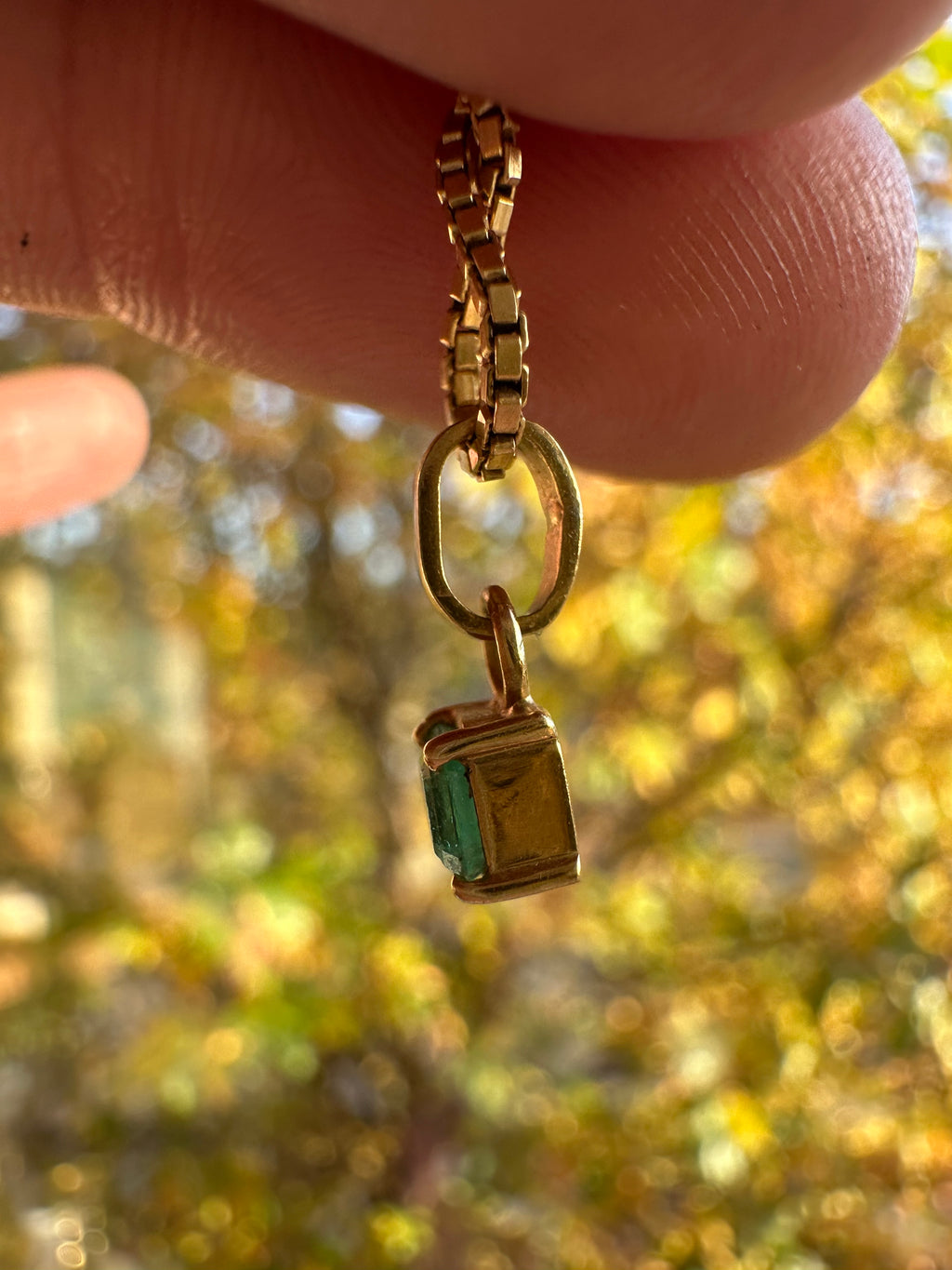 step cut square emerald and 18k gold charm