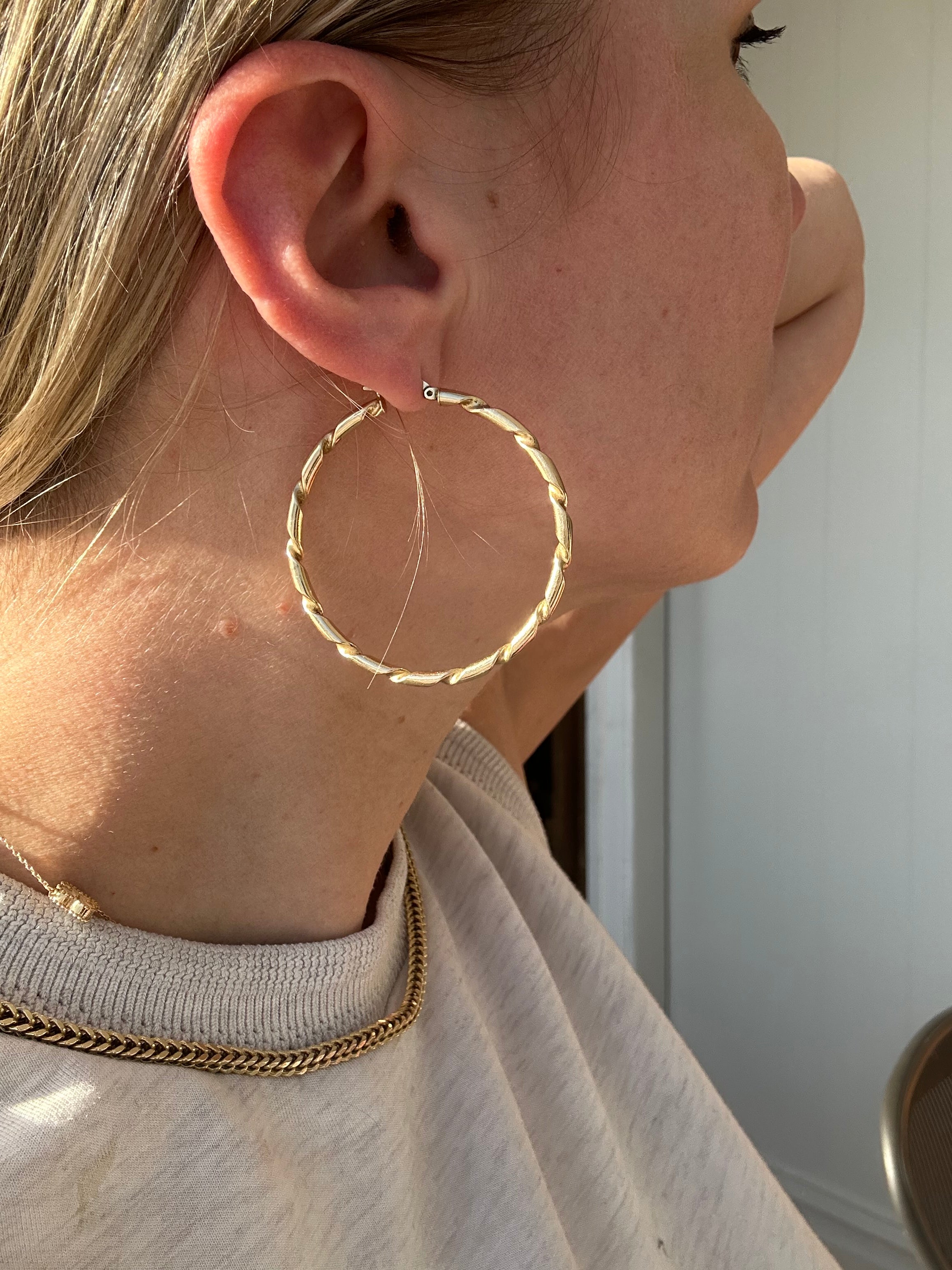 2" solid gold hoops with ribbon design