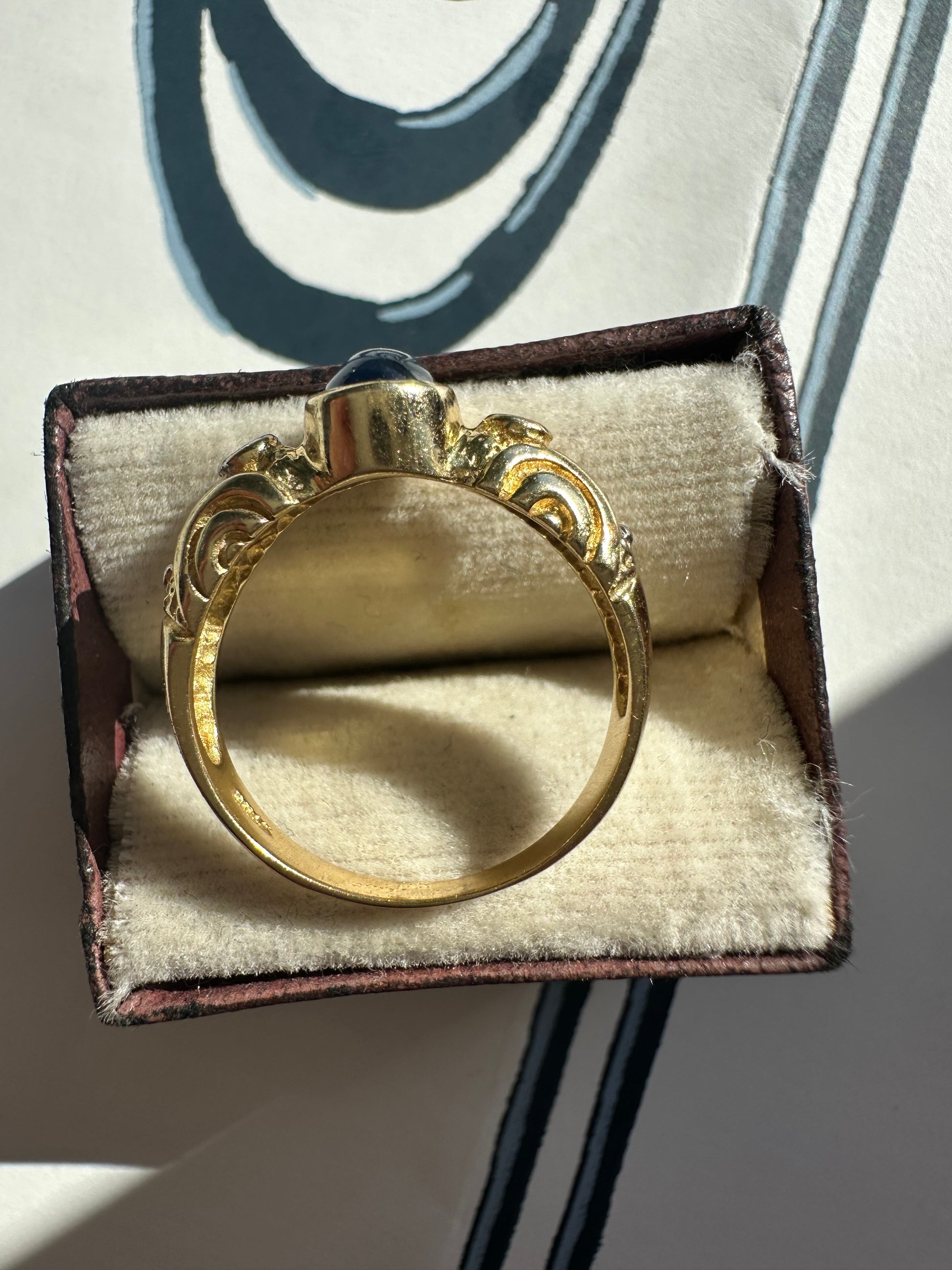 sapphire cabochon and bezel set diamonds