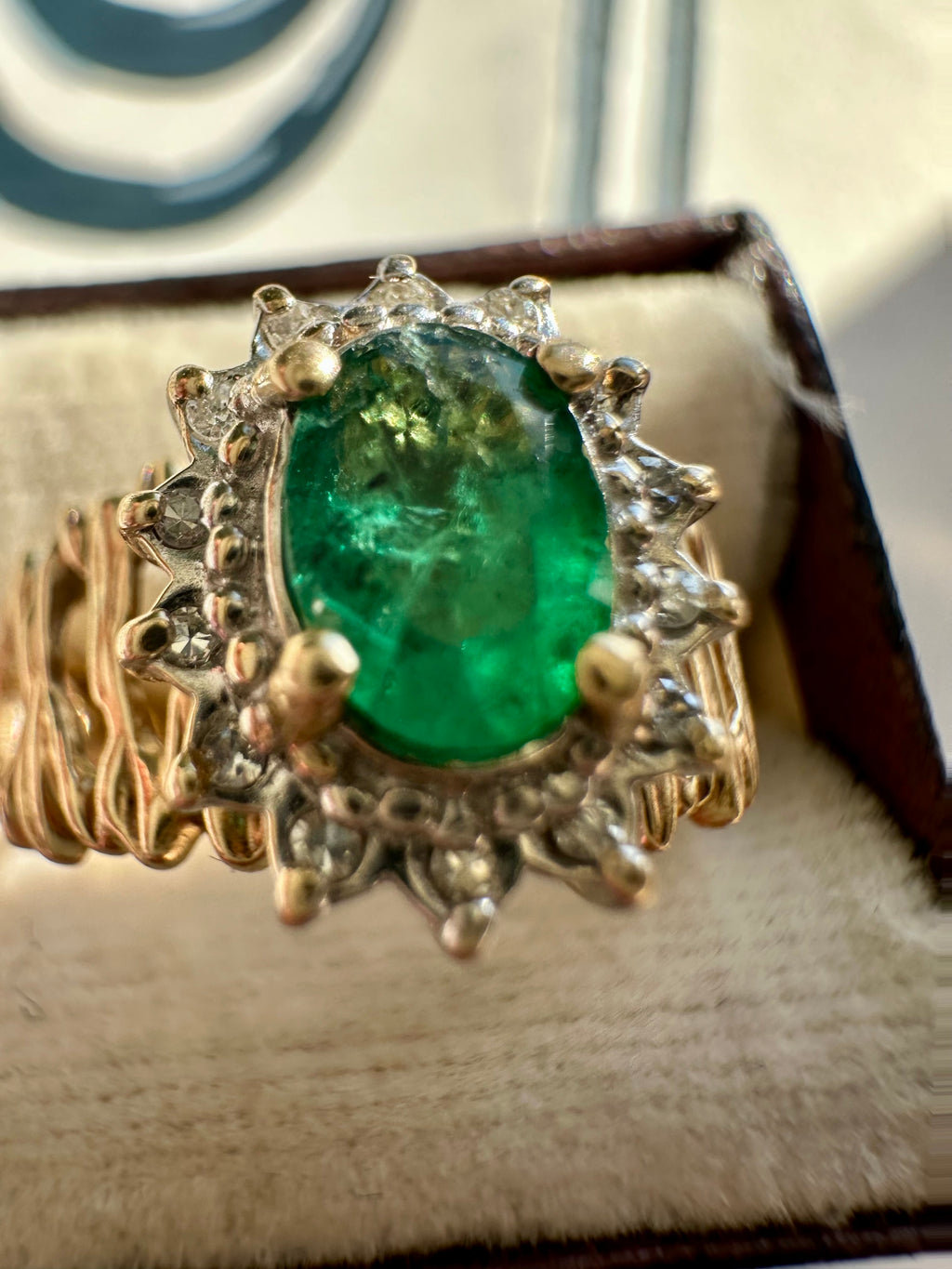 oval cut emerald with diamond halo