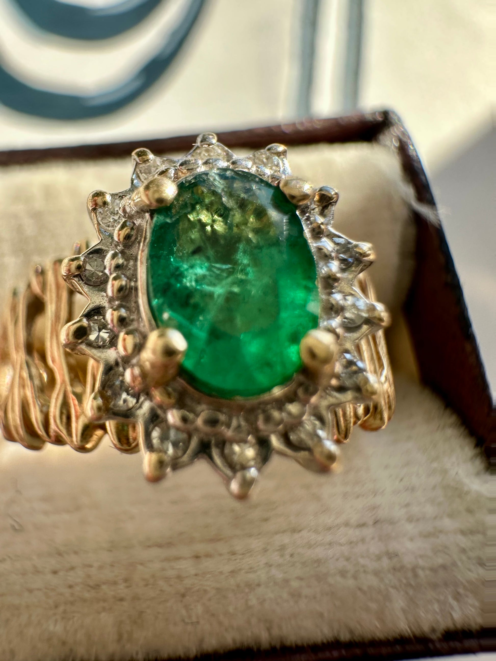oval cut emerald with diamond halo