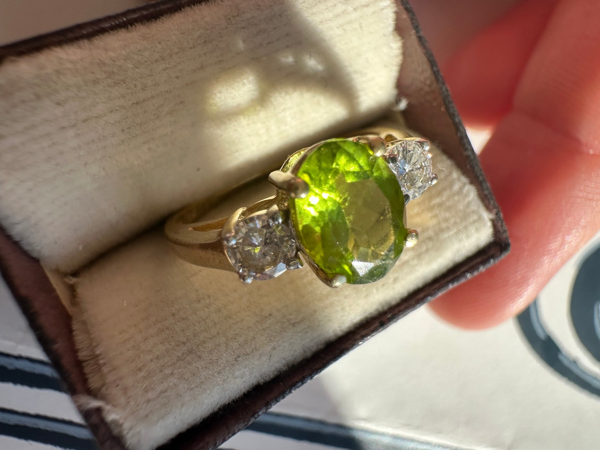 oval peridot and round cut diamond ring