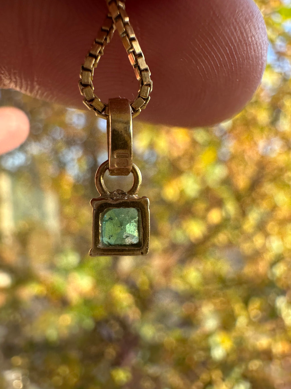 step cut square emerald and 18k gold charm