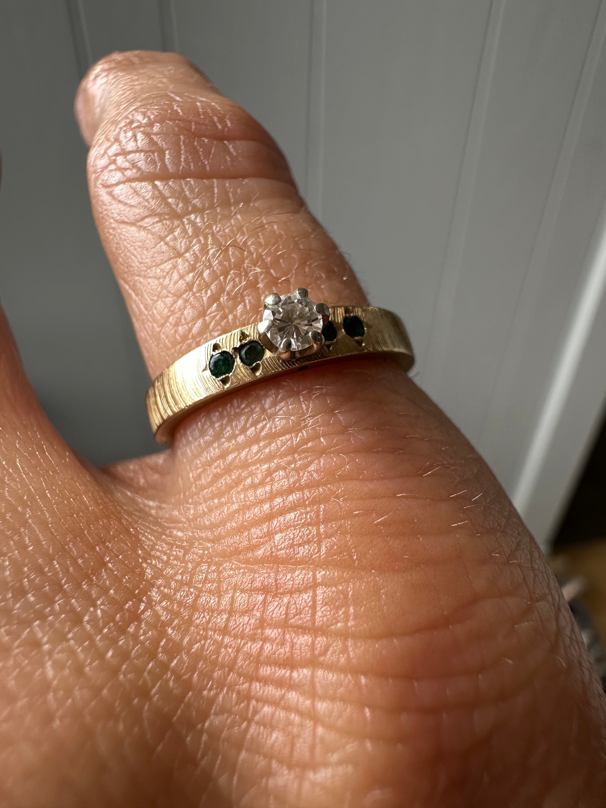 solitare diamond with emerald accents