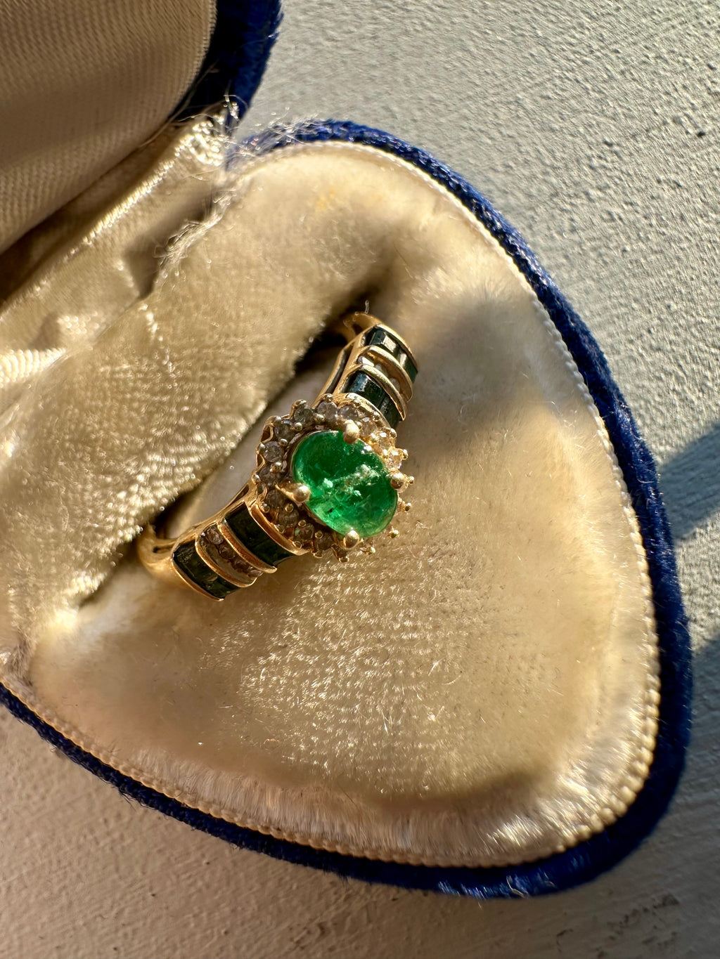 oval cut emerald with diamond halo ring