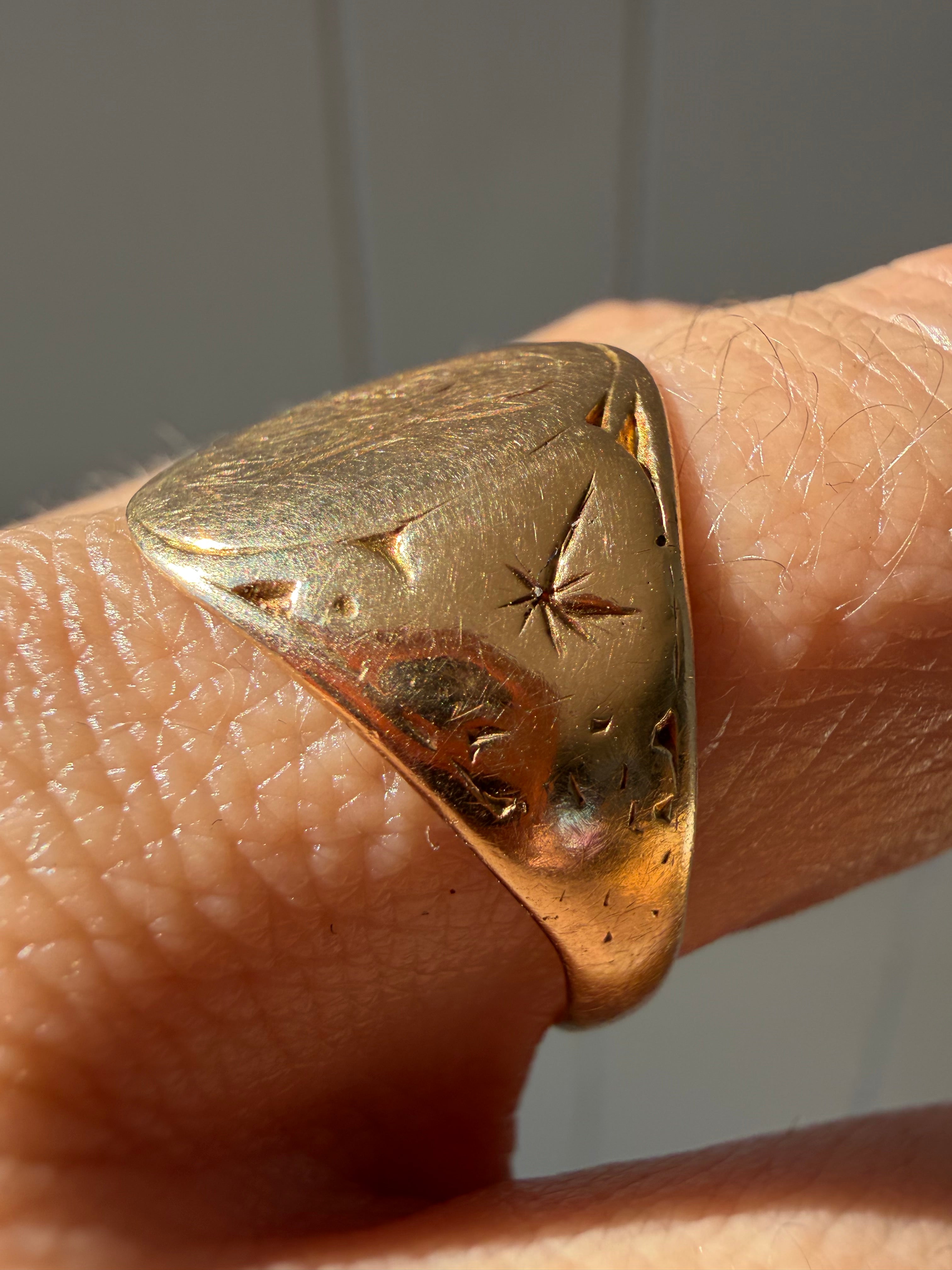 hand engraved worn signet with starbursts
