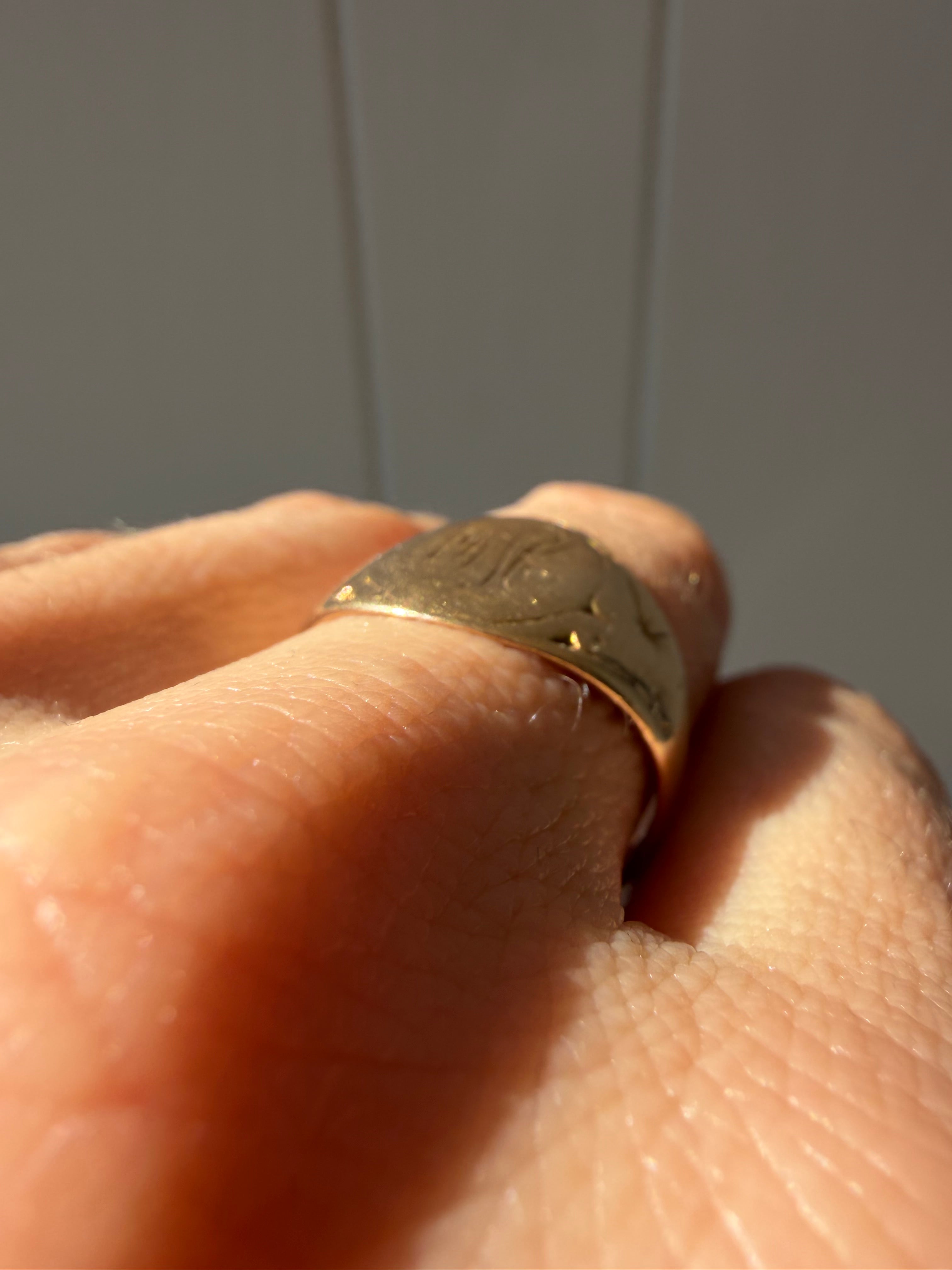 hand engraved worn signet with starbursts