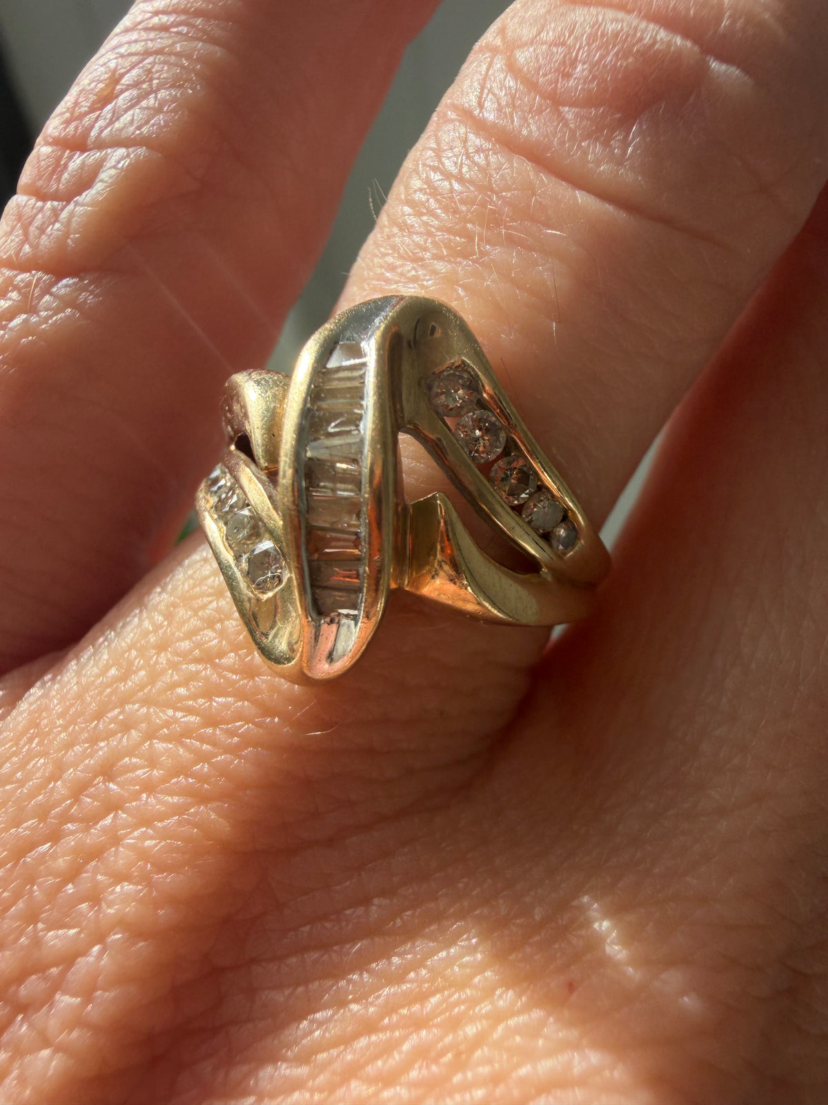 ribbon style baguette and round cut diamond ring