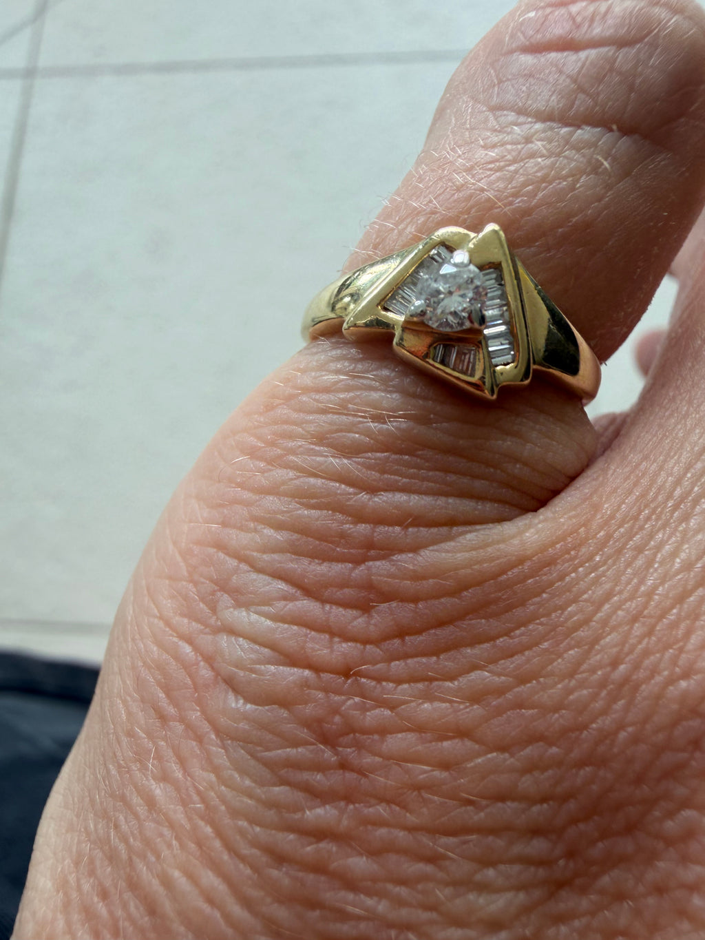 triangle ring with baguettes and round diamond
