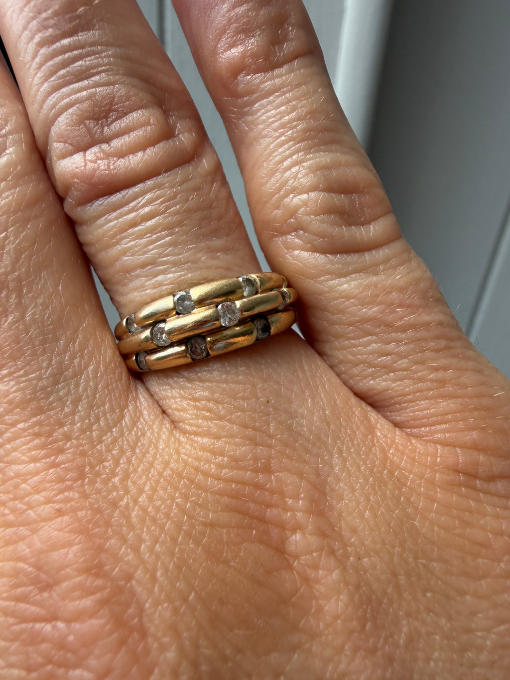 triple gold band with spaced diamonds