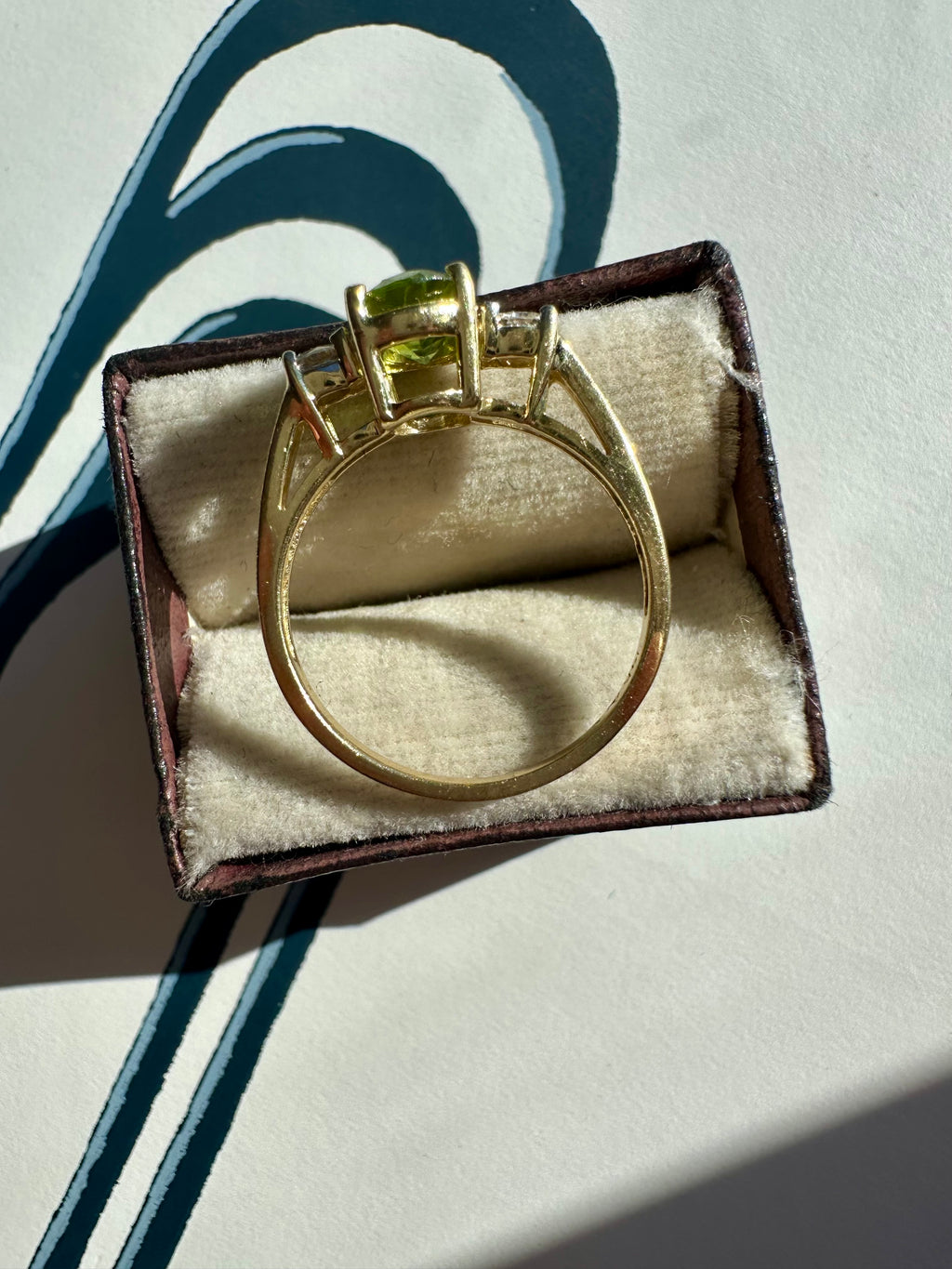 oval peridot and round cut diamond ring