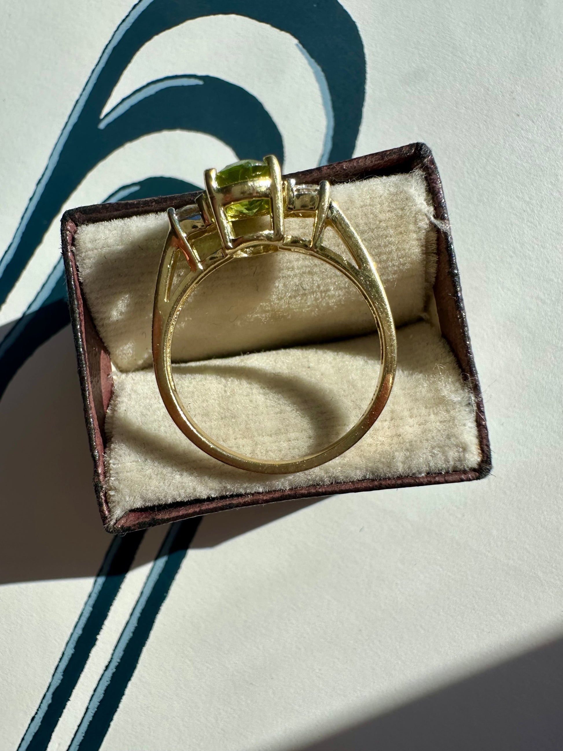 oval peridot and round cut diamond ring