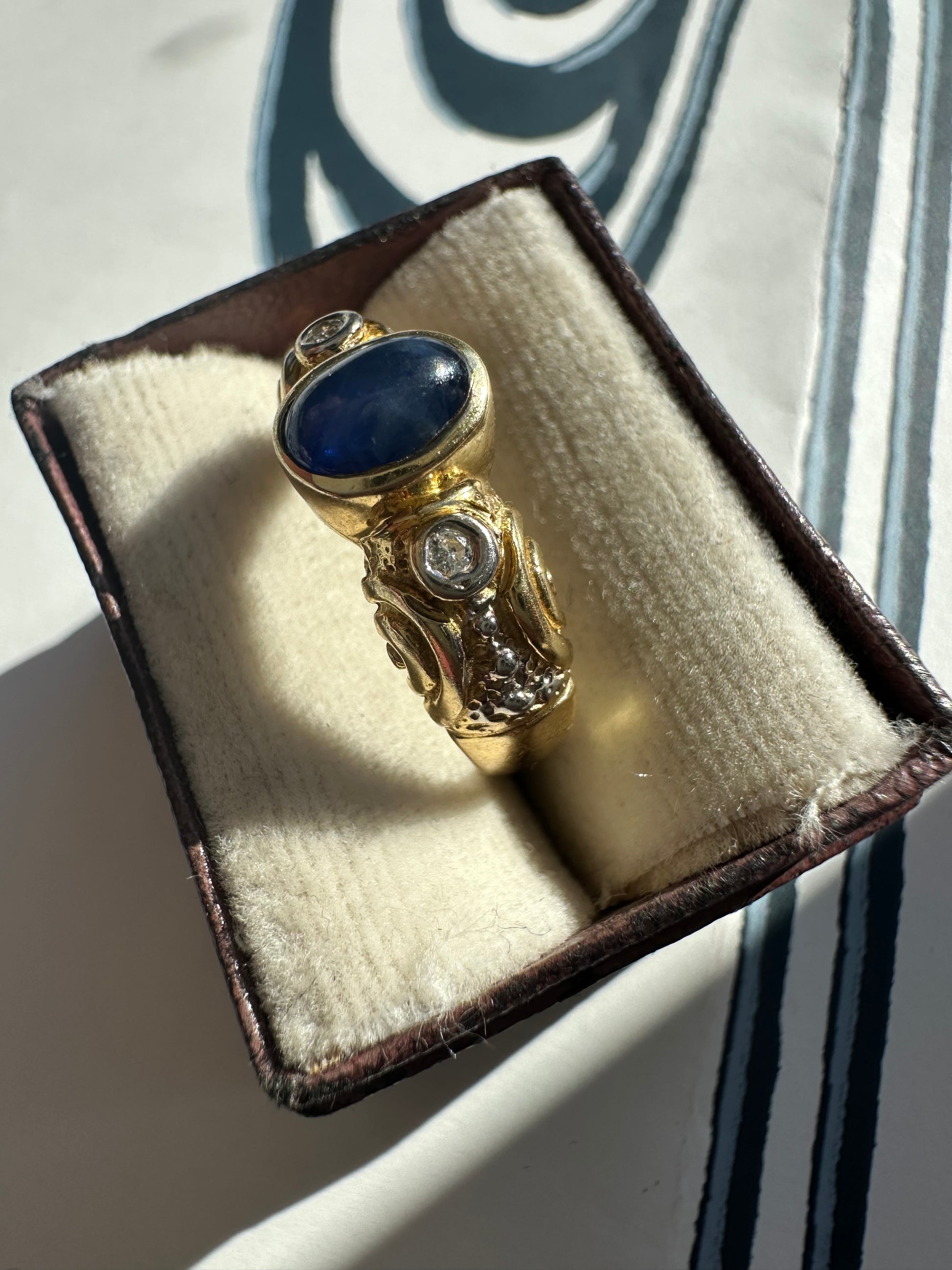 sapphire cabochon and bezel set diamonds