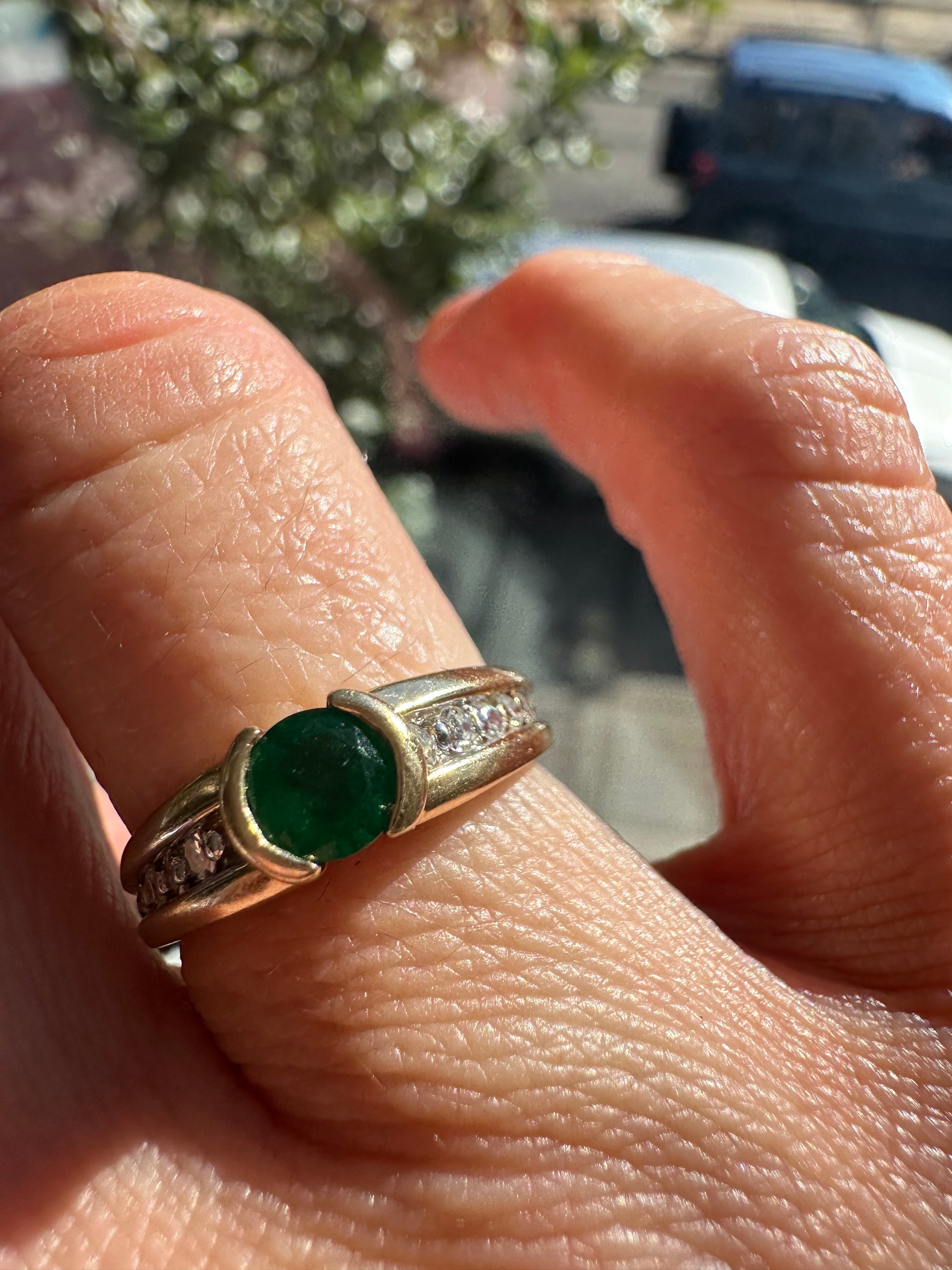 round emerald and two tone diamond band