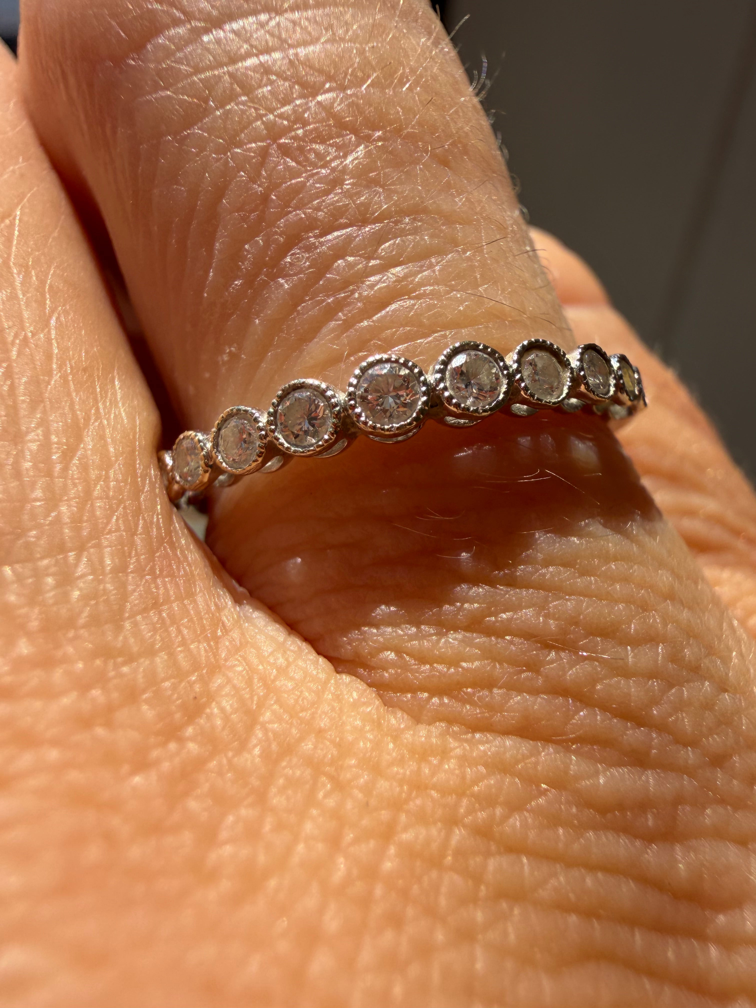 18k white gold millgrain detail bezel set diamond band