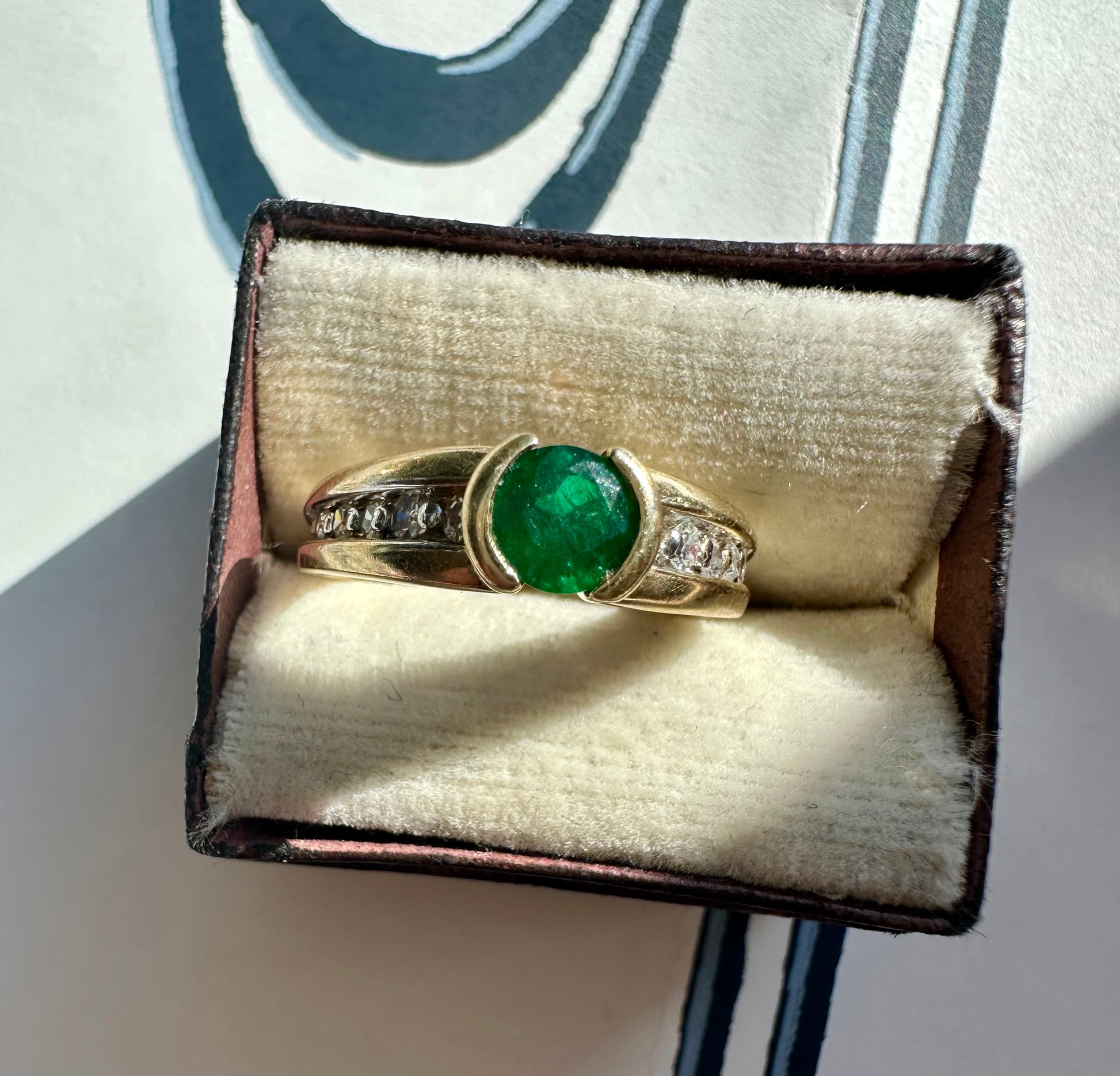 round emerald and two tone diamond band