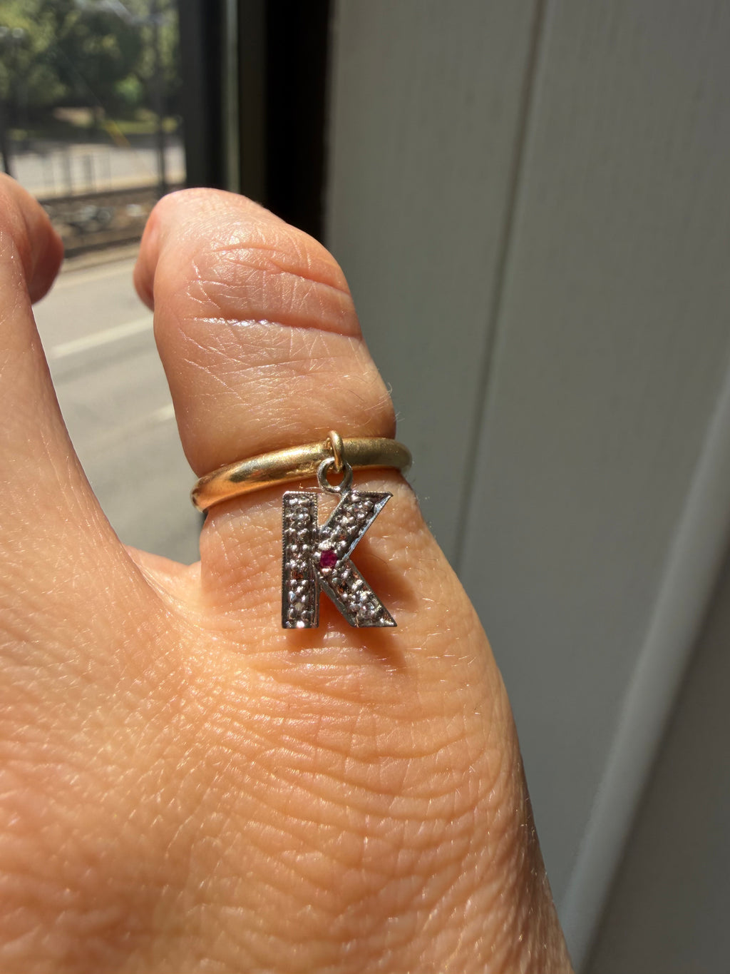 yellow gold donut with white gold diamond and ruby K charm
