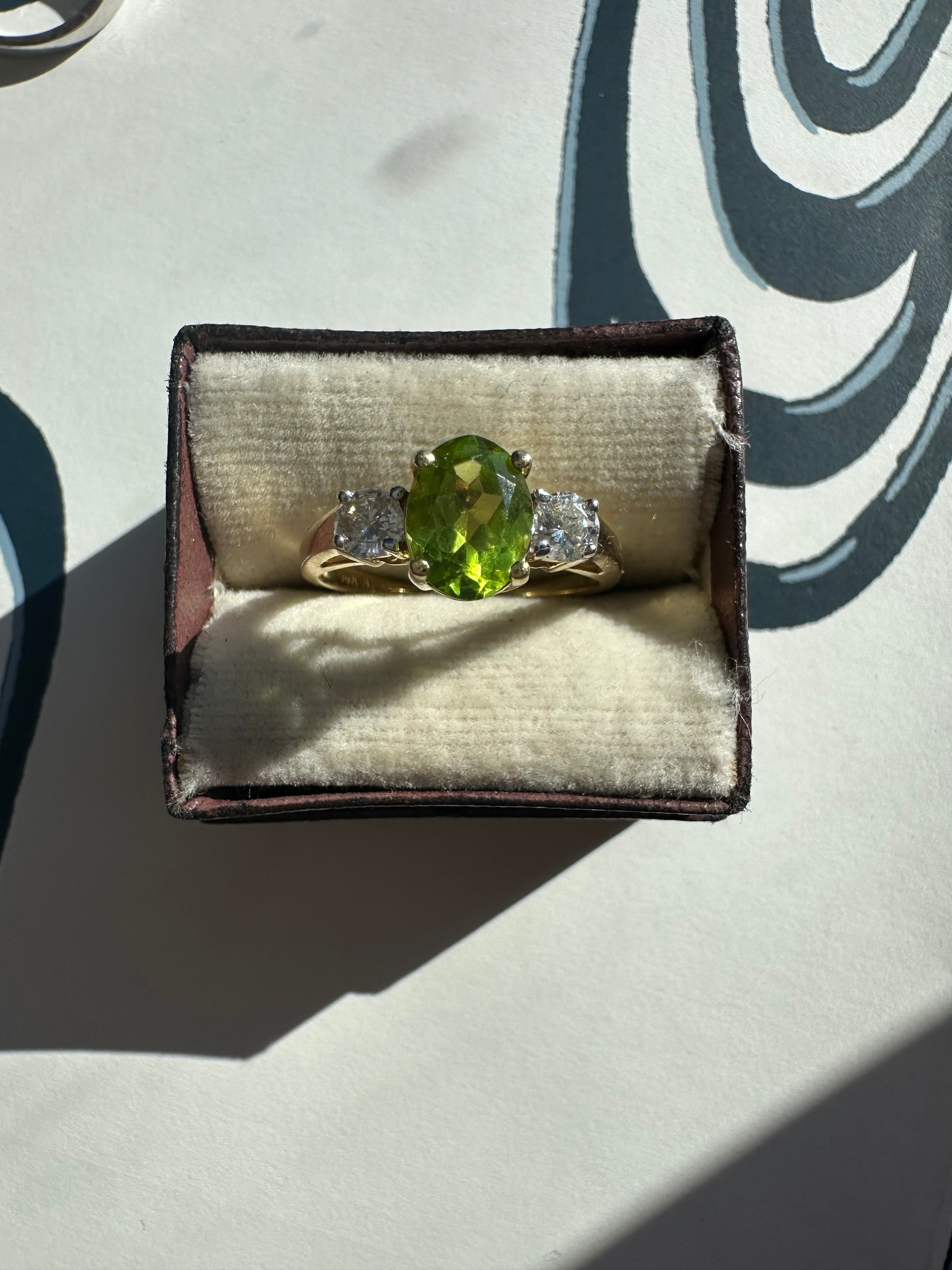 oval peridot and round cut diamond ring