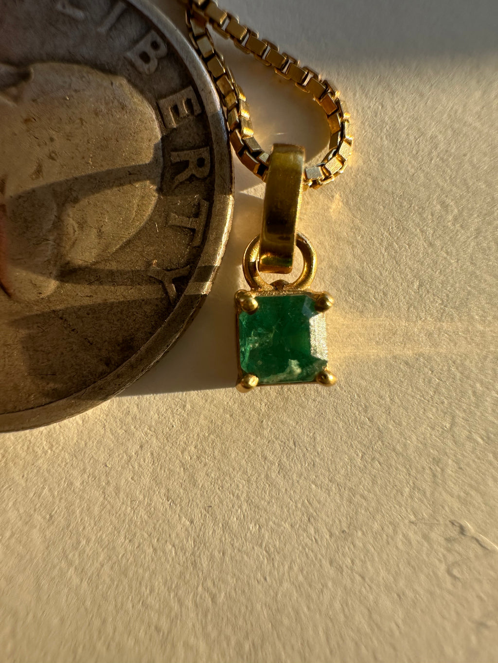 step cut square emerald and 18k gold charm