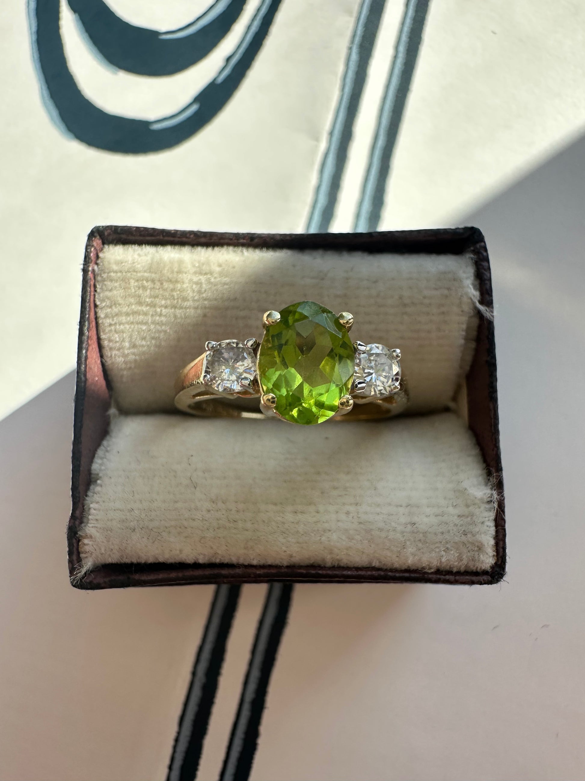 oval peridot and round cut diamond ring
