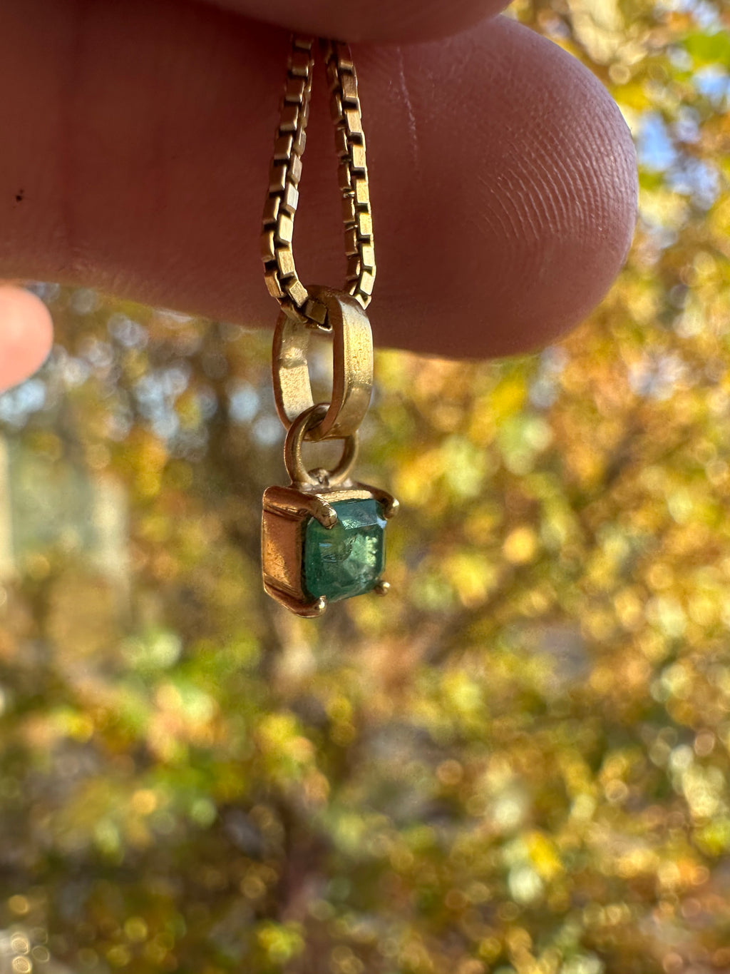 step cut square emerald and 18k gold charm
