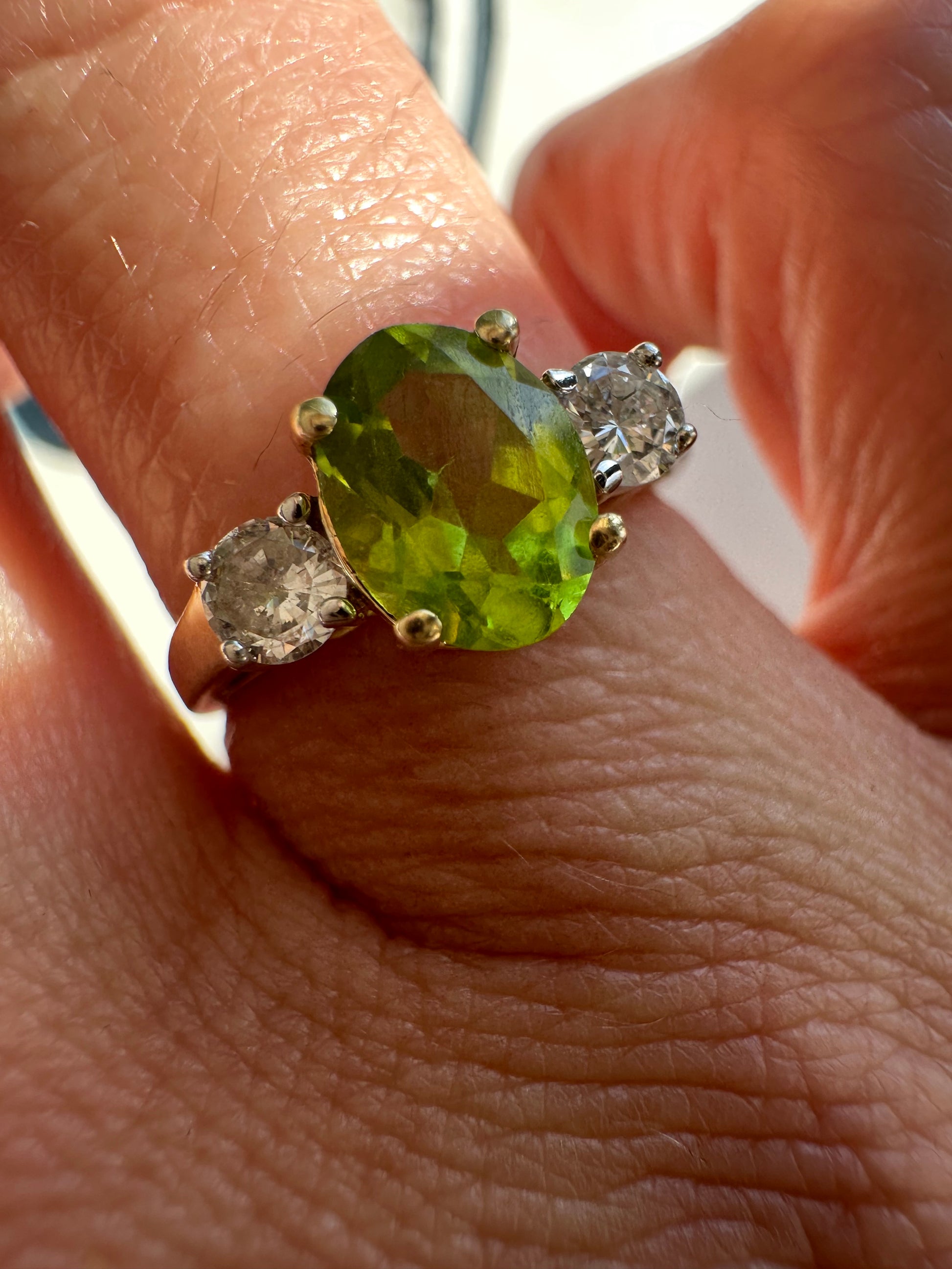 oval peridot and round cut diamond ring