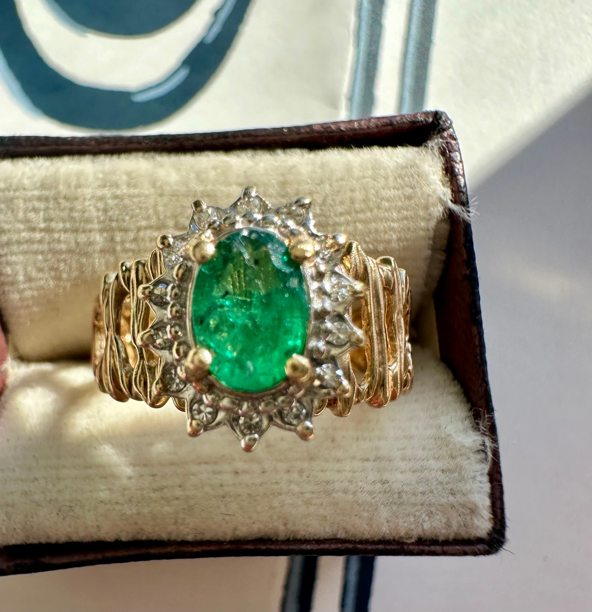 oval cut emerald with diamond halo