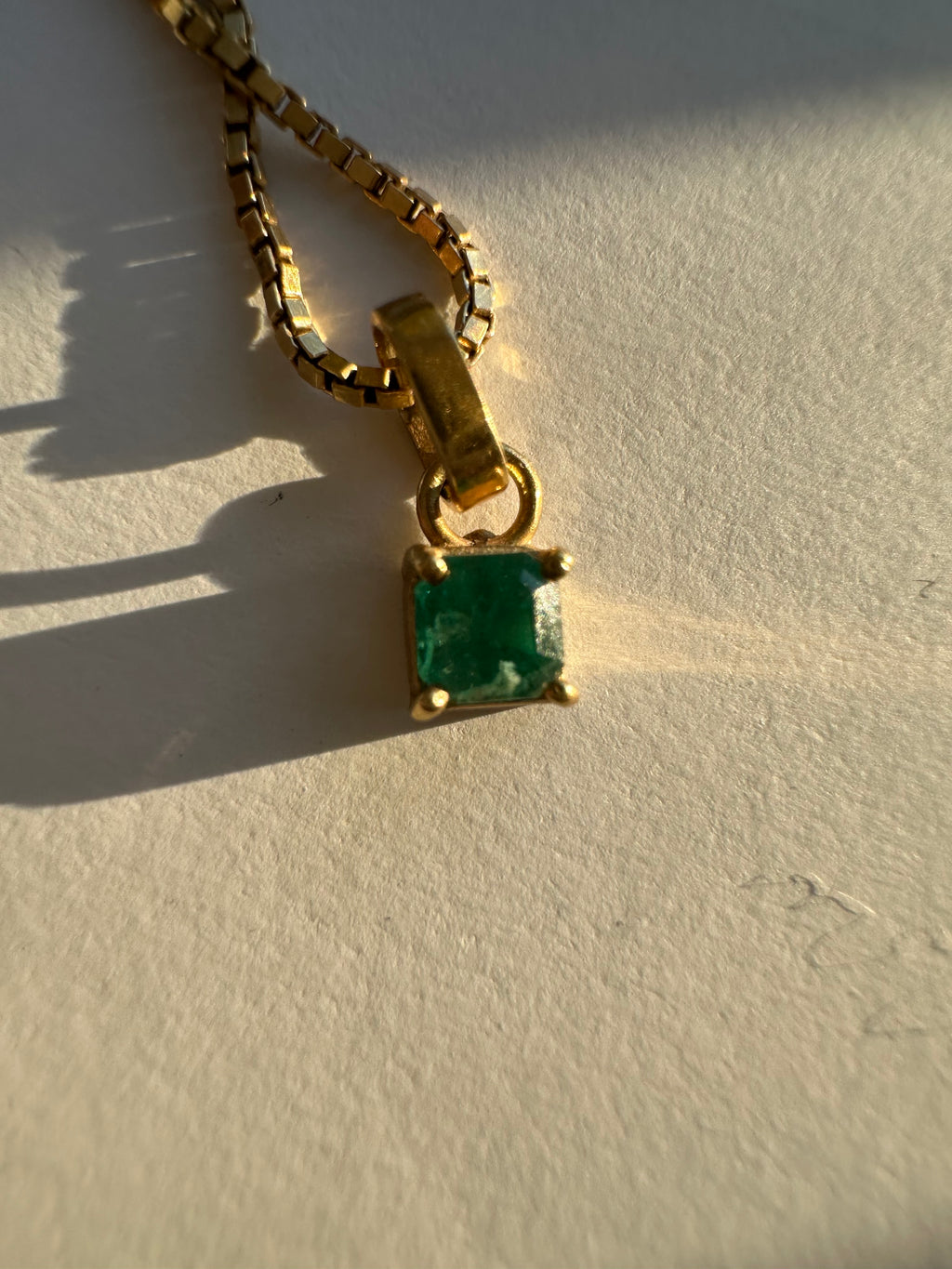 step cut square emerald and 18k gold charm