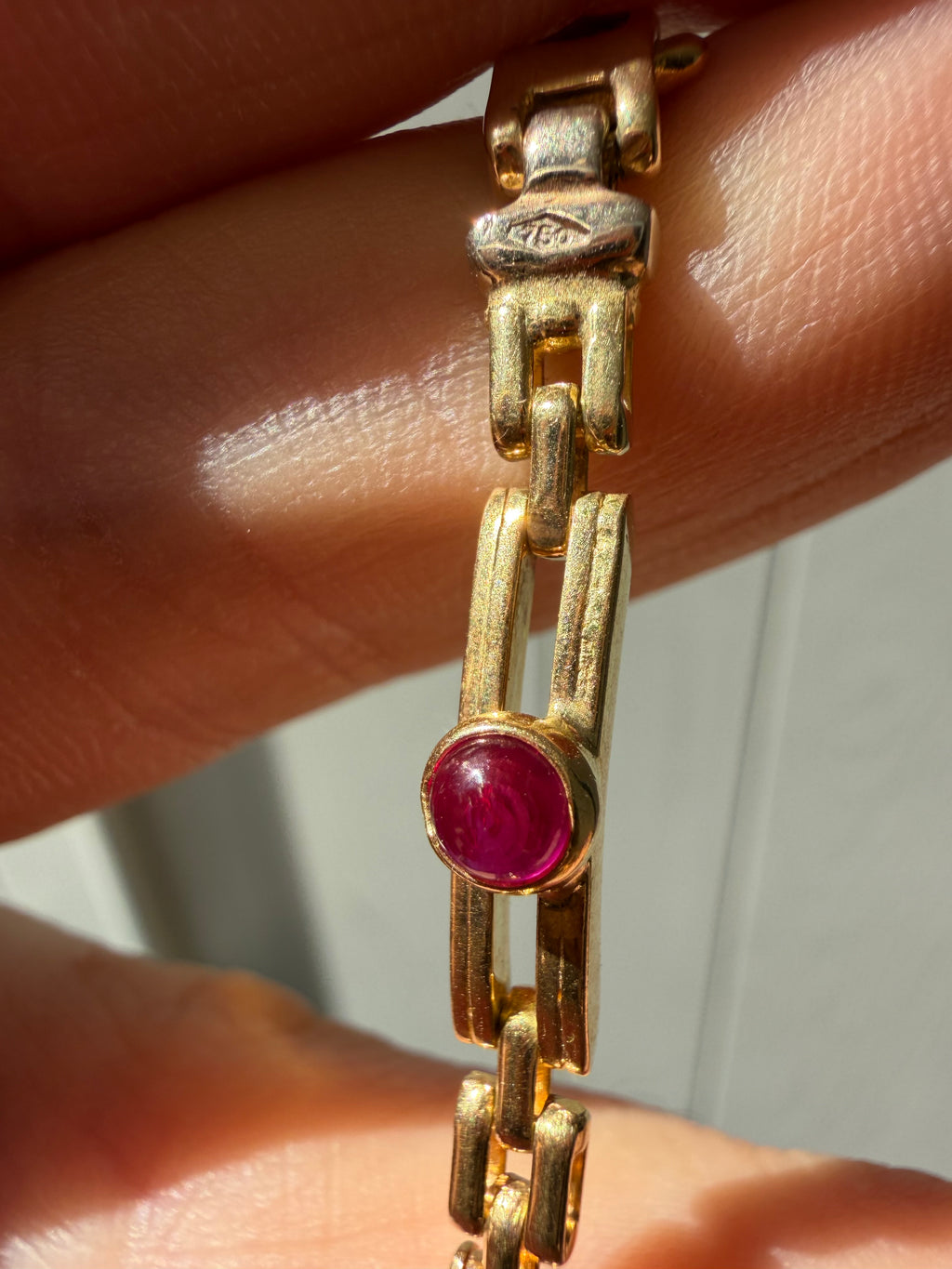 18k gold open bar link bracelet with ruby cabochon