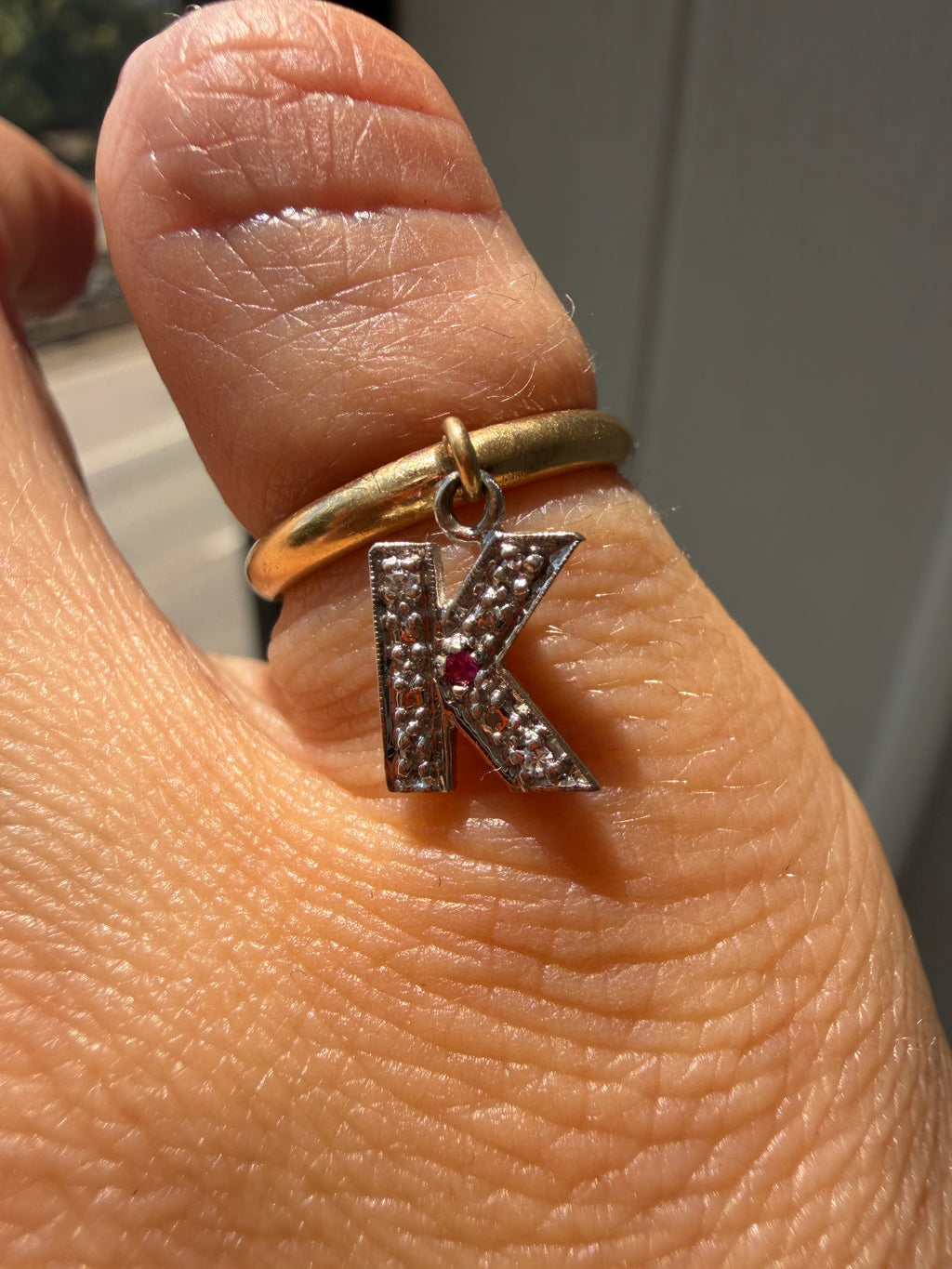 yellow gold donut with white gold diamond and ruby K charm