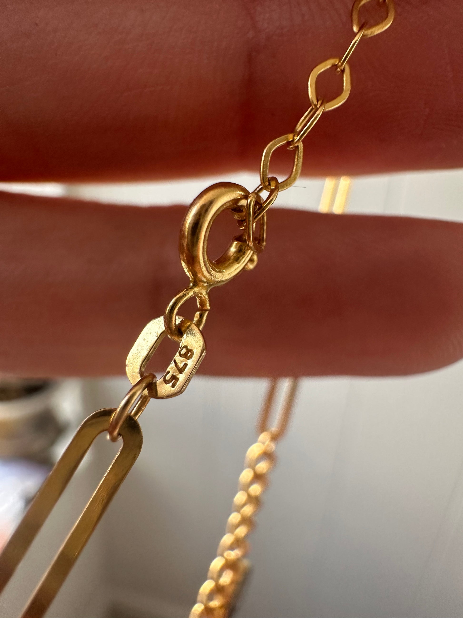 21k gold paperlink and curb charm bracelet