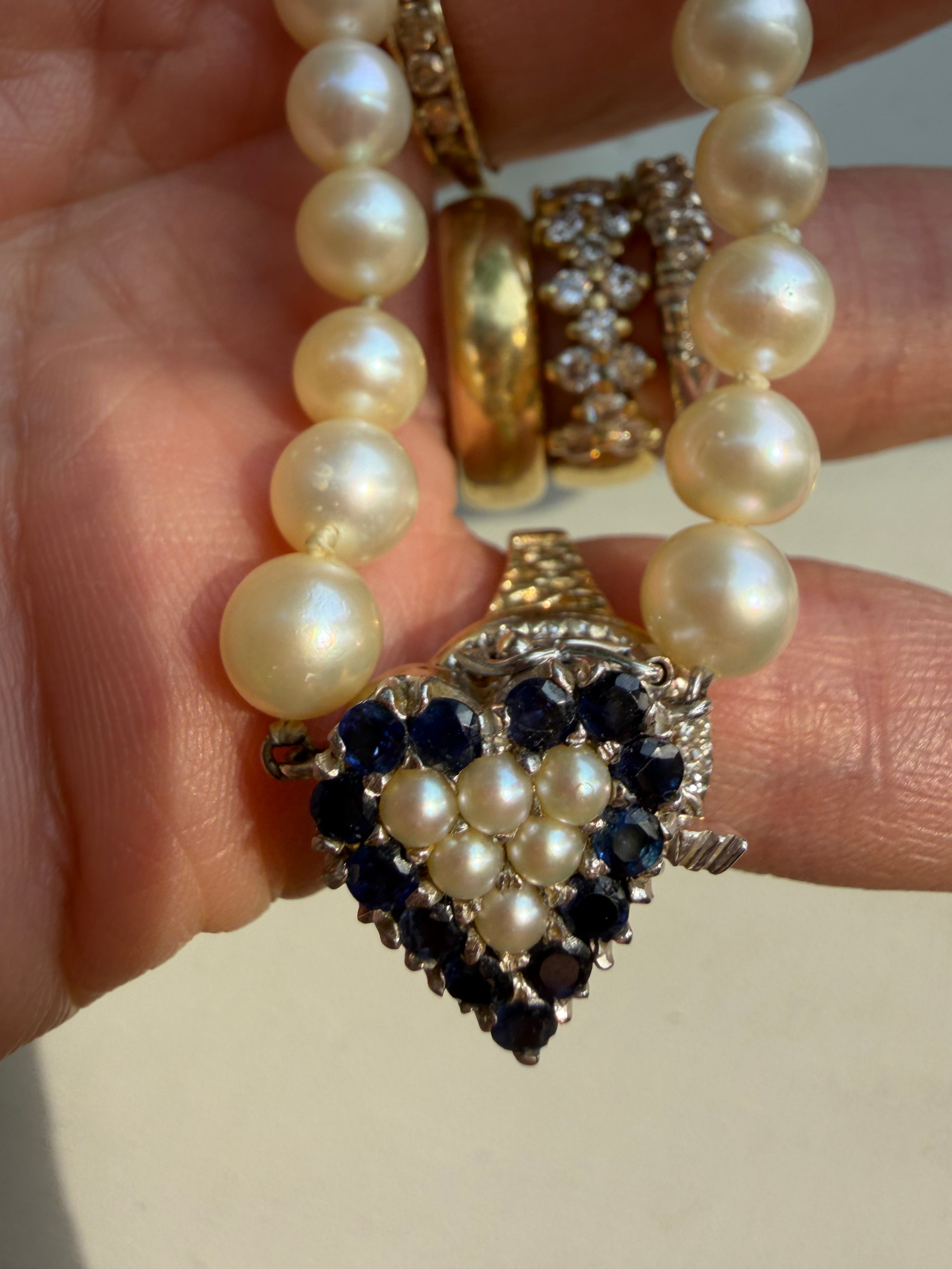 pearl strand with sapphire and pearl heart white gold clasp